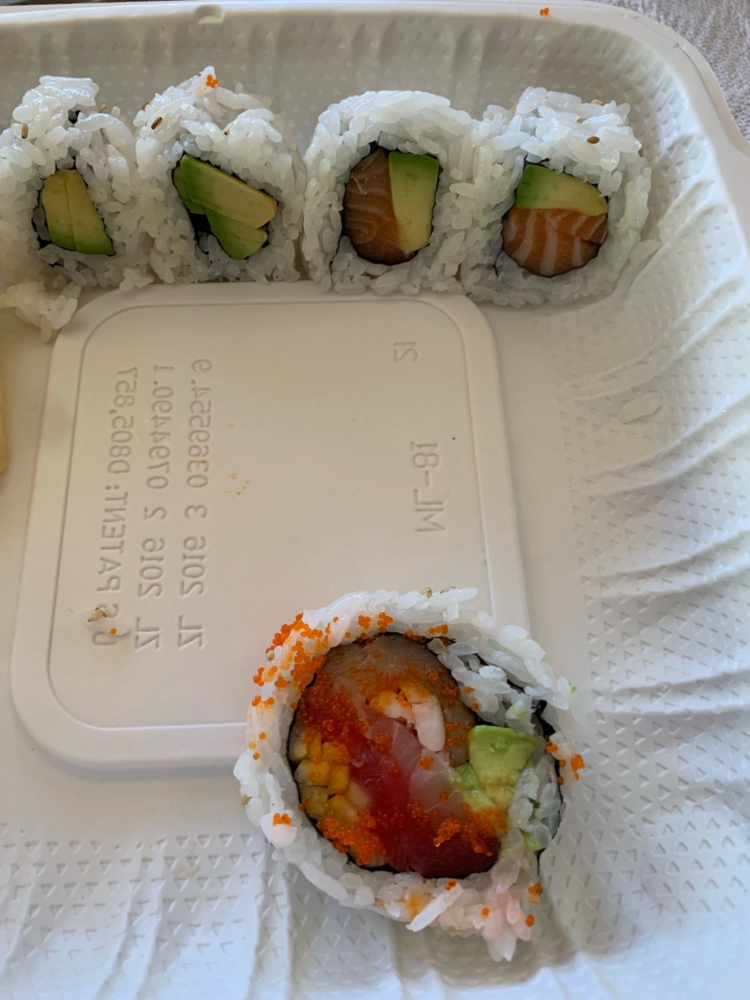 An almost empty take out box of sushi