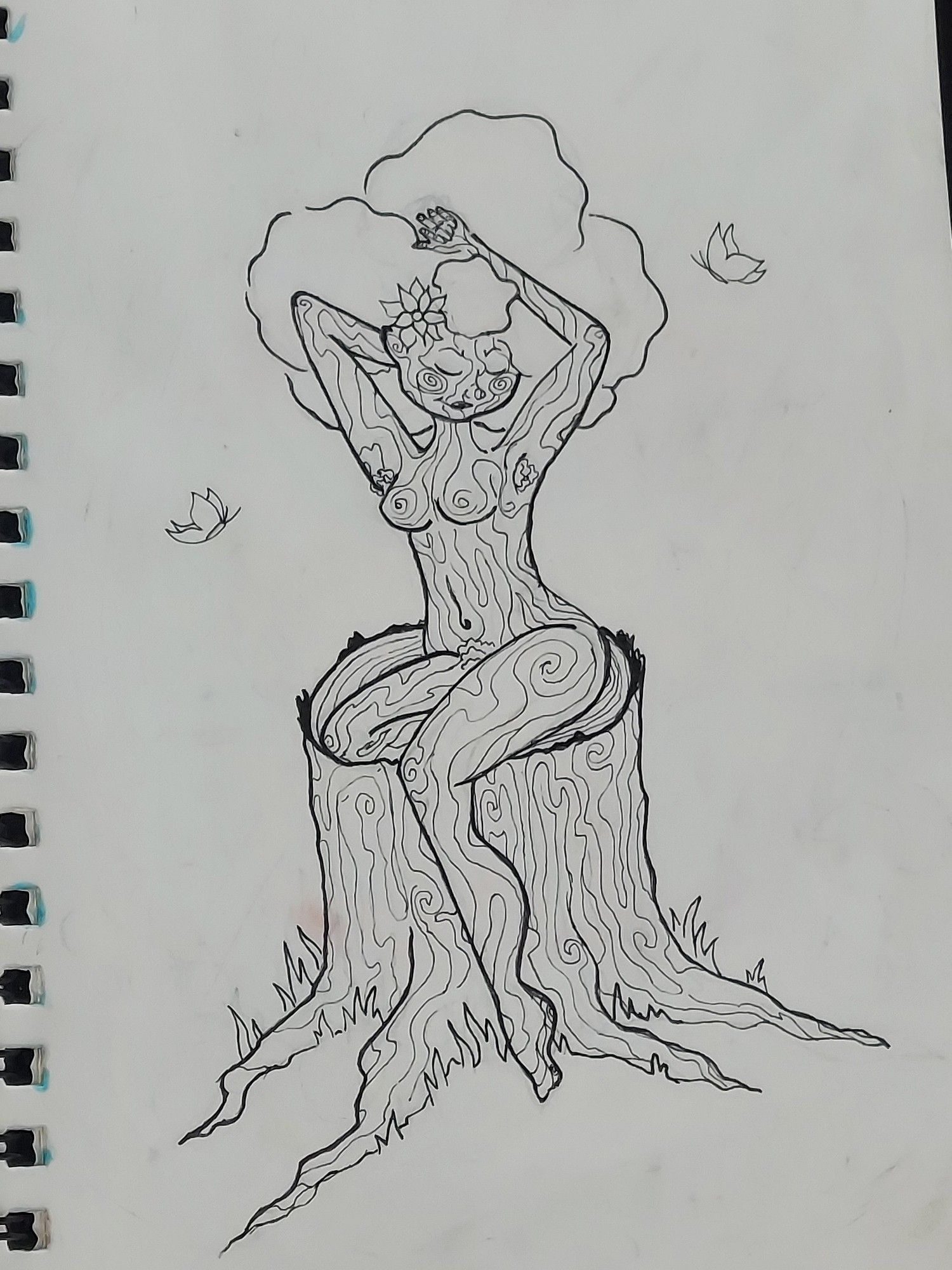 An ink drawing of a naked tree lady. She's got skin that looks like bark and a leafy afro. she is siting on a tree stump pin up style with butterfly's around her.