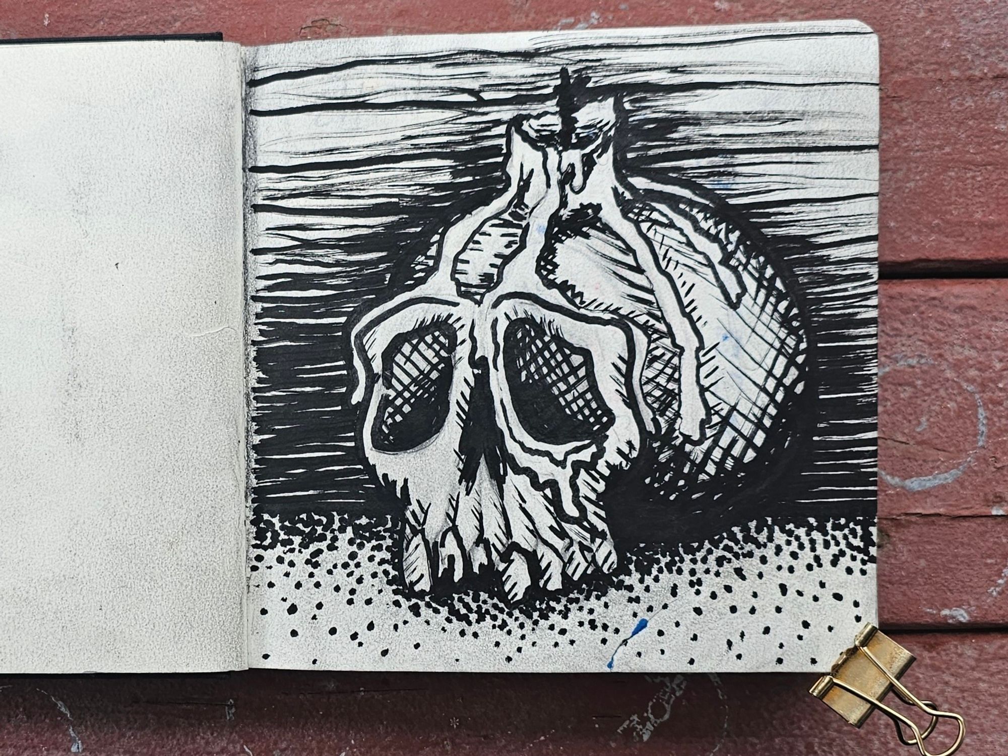 A drawing of a skull with a used candle on top. The wax is dripping down the skull going into one of the eye holes. Made with black poscamarker.