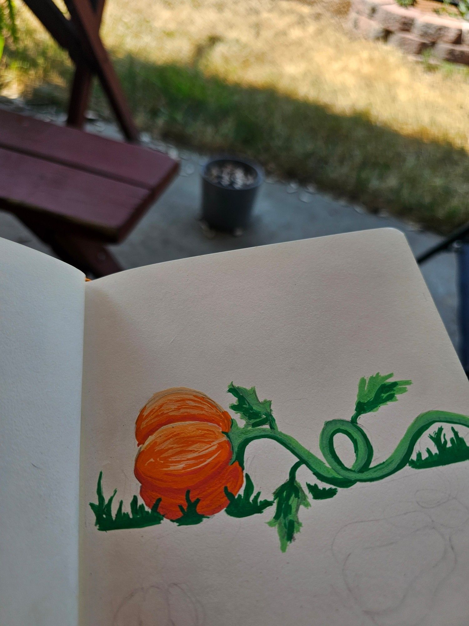 Pictured is Adolin's drawing of a pumpkin on its side with a twisty stem. Done with poscamarkers.