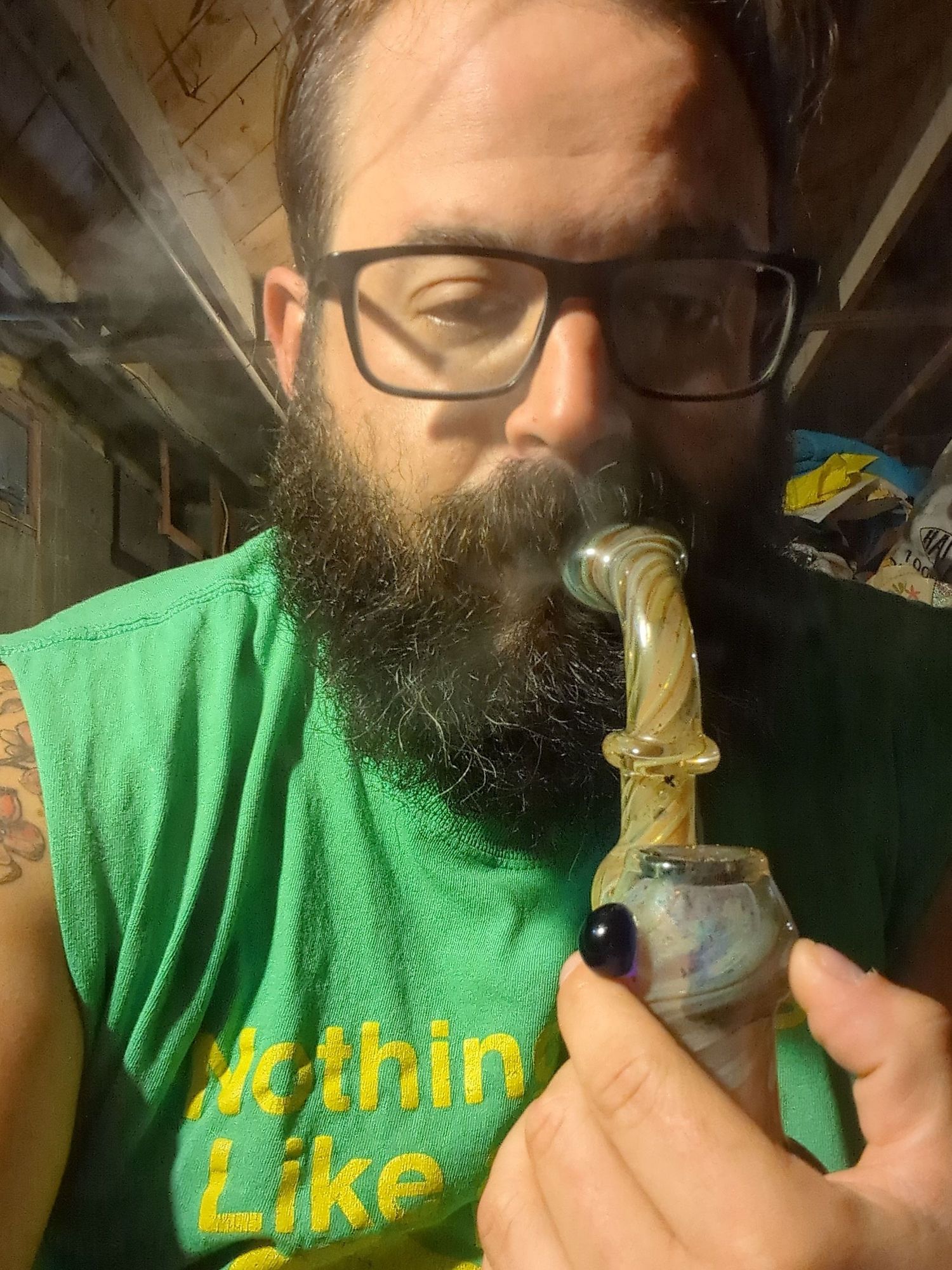 me wearing glasses smoking out of a bubbler