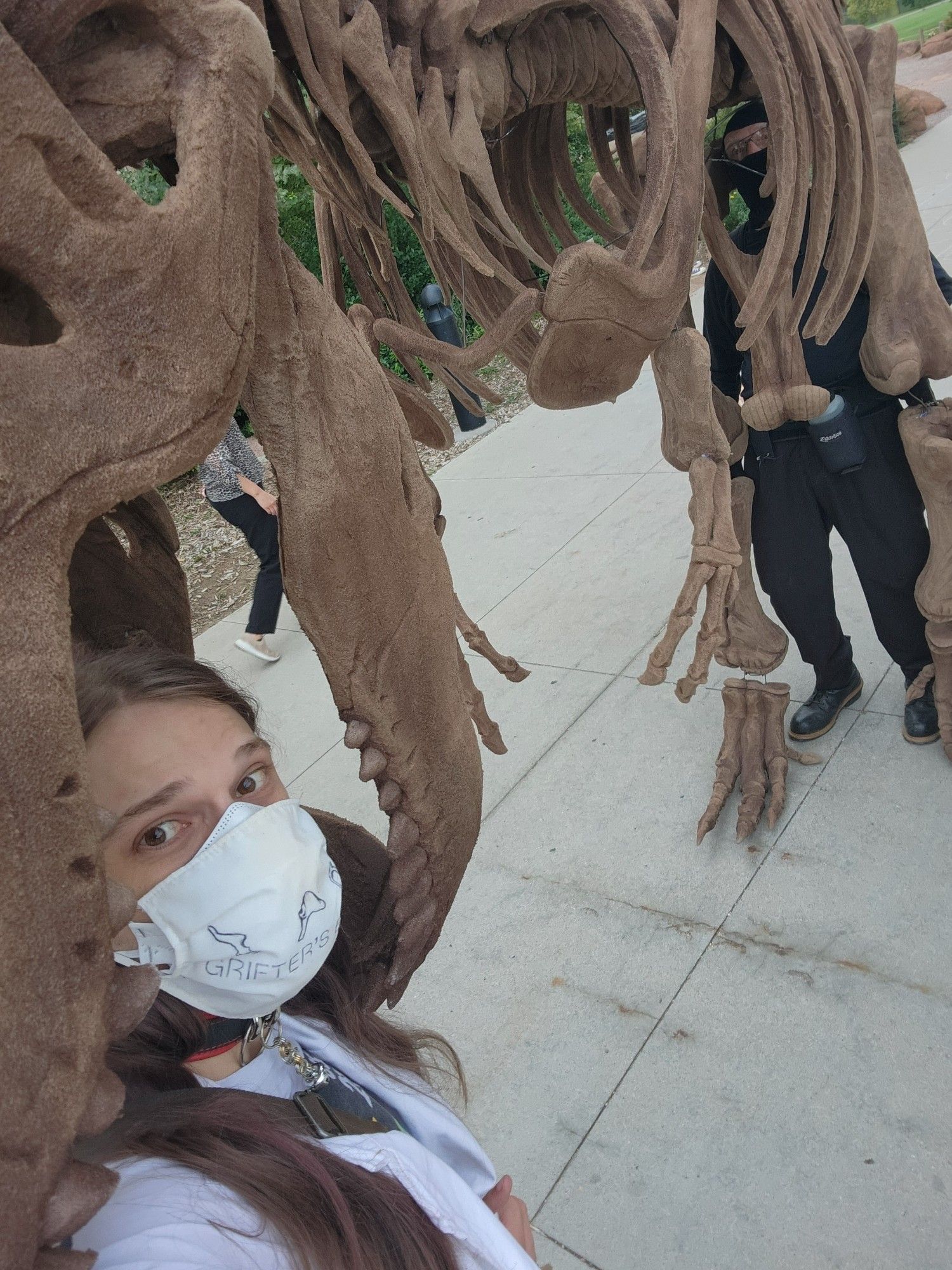 selfie of eli in the jaws of a bug dinosaur skeleton puppet