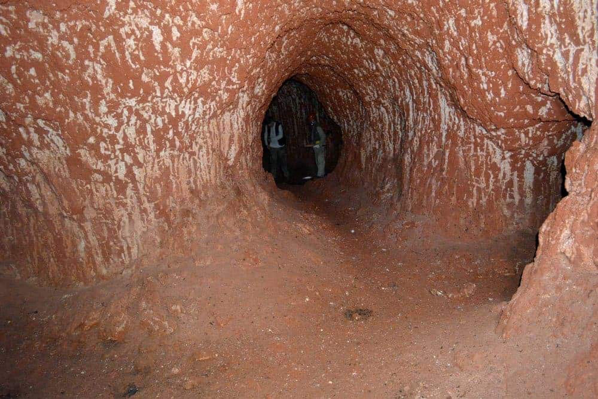 A burrow produced by the extinct mega-sloths that once roamed South America. It looks like a rabbit burrow until you see a group of fully grown men in the distance with several feet of clearance above their heads.