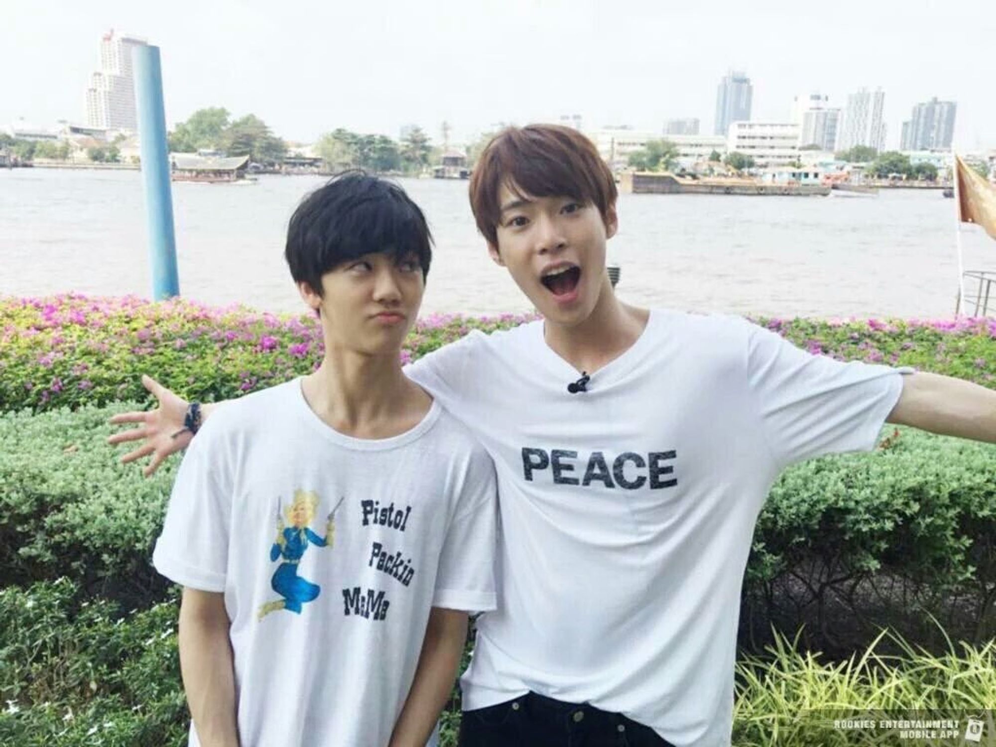 super adorable photo of rookies jaemin and doyoung, they're both wearing white shirts with sayings on them and jaemin is pouting up at doyoung while doyoung has his arms spread in surprise(?) happiness(?)