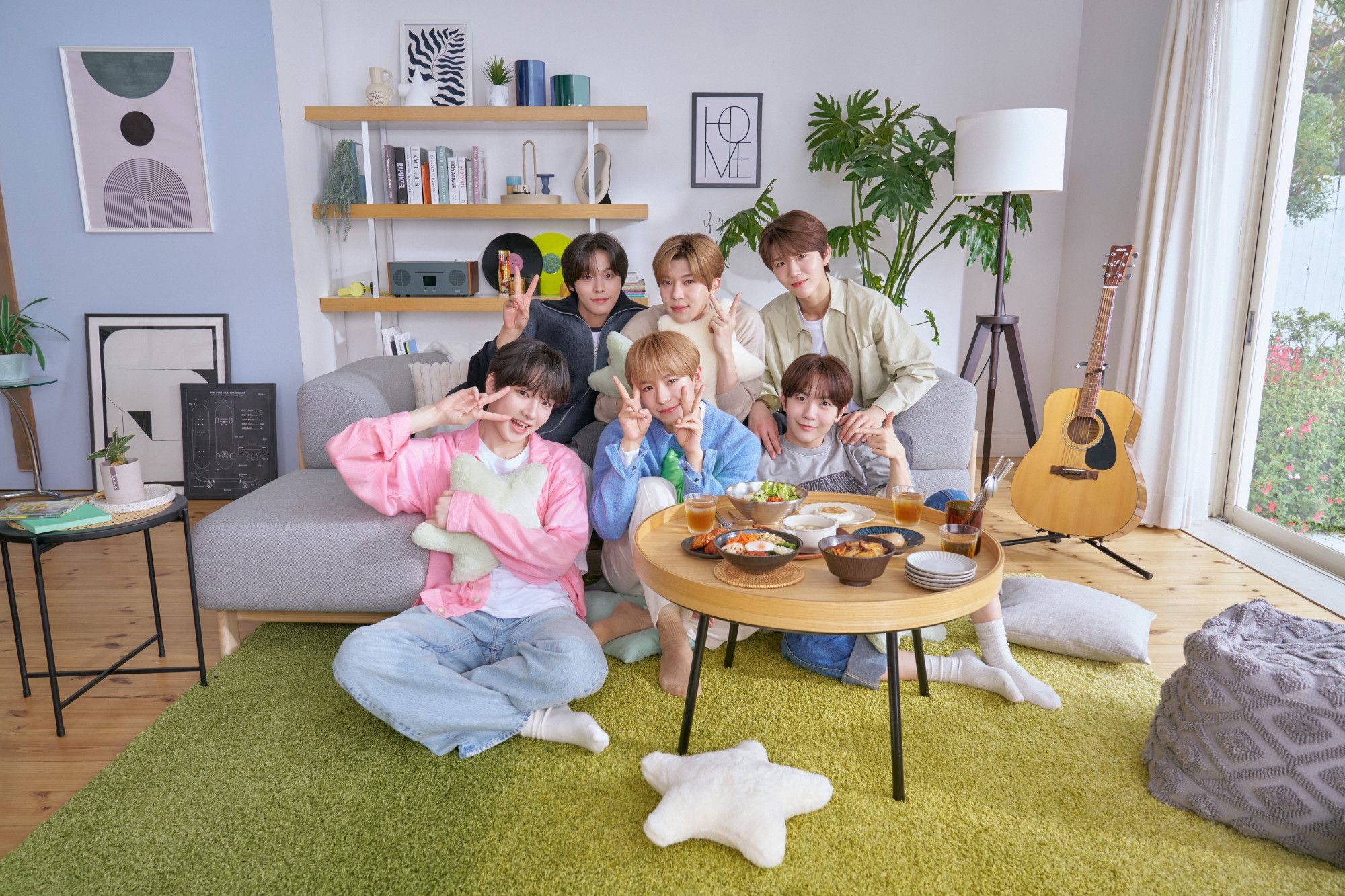 a very cutieful group photo of nct wish in a living room setting. left to right, from the back: riku, sion, jaehee, sakuya, yushi, and ryo