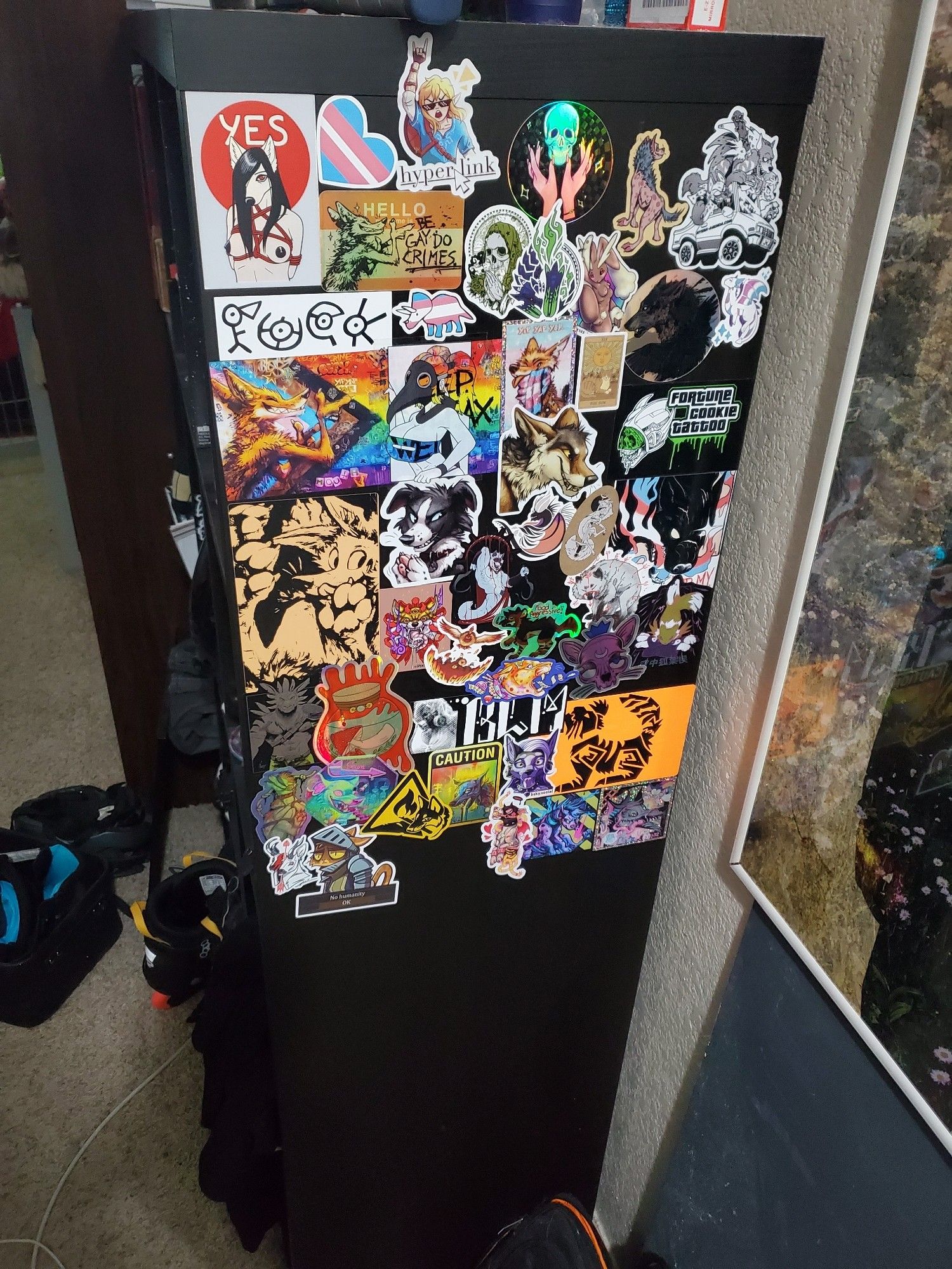 The side of a kallax (Ikea furniture loved by boardgamers) that I've been slapping stickers on as i get them.