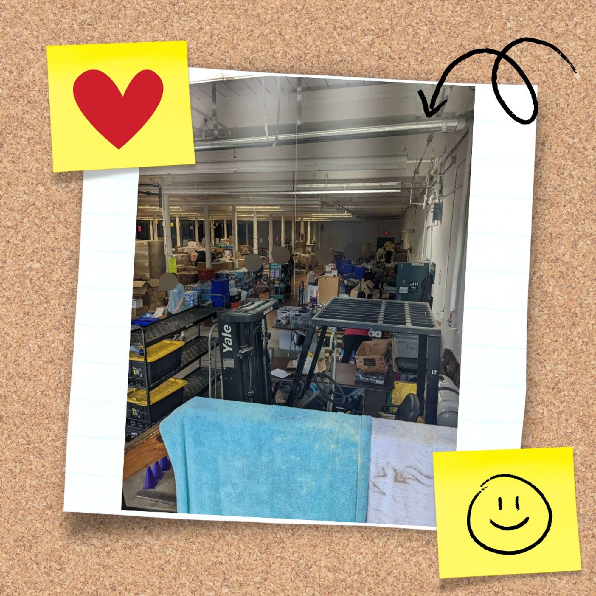 The warehouse being used as an aid hub. There are many shelving units full of items that have been dropped off to be distributed to people in need.