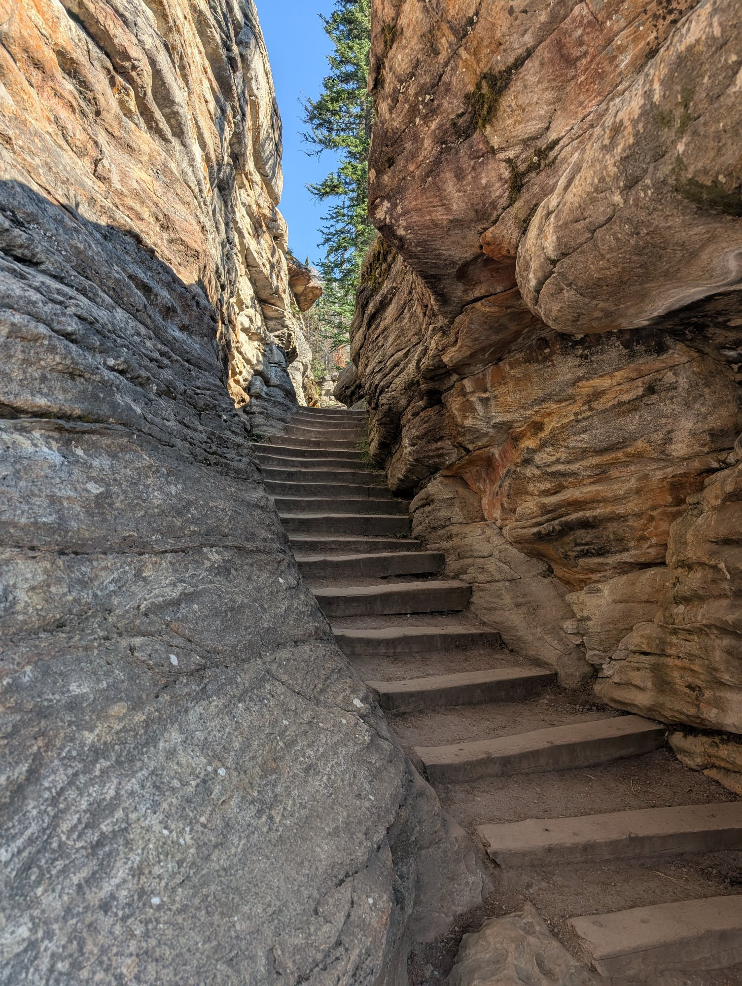A staircase that passes through the gaps carved in rock by water over time. This is at Athabasca Falls, Alberta.