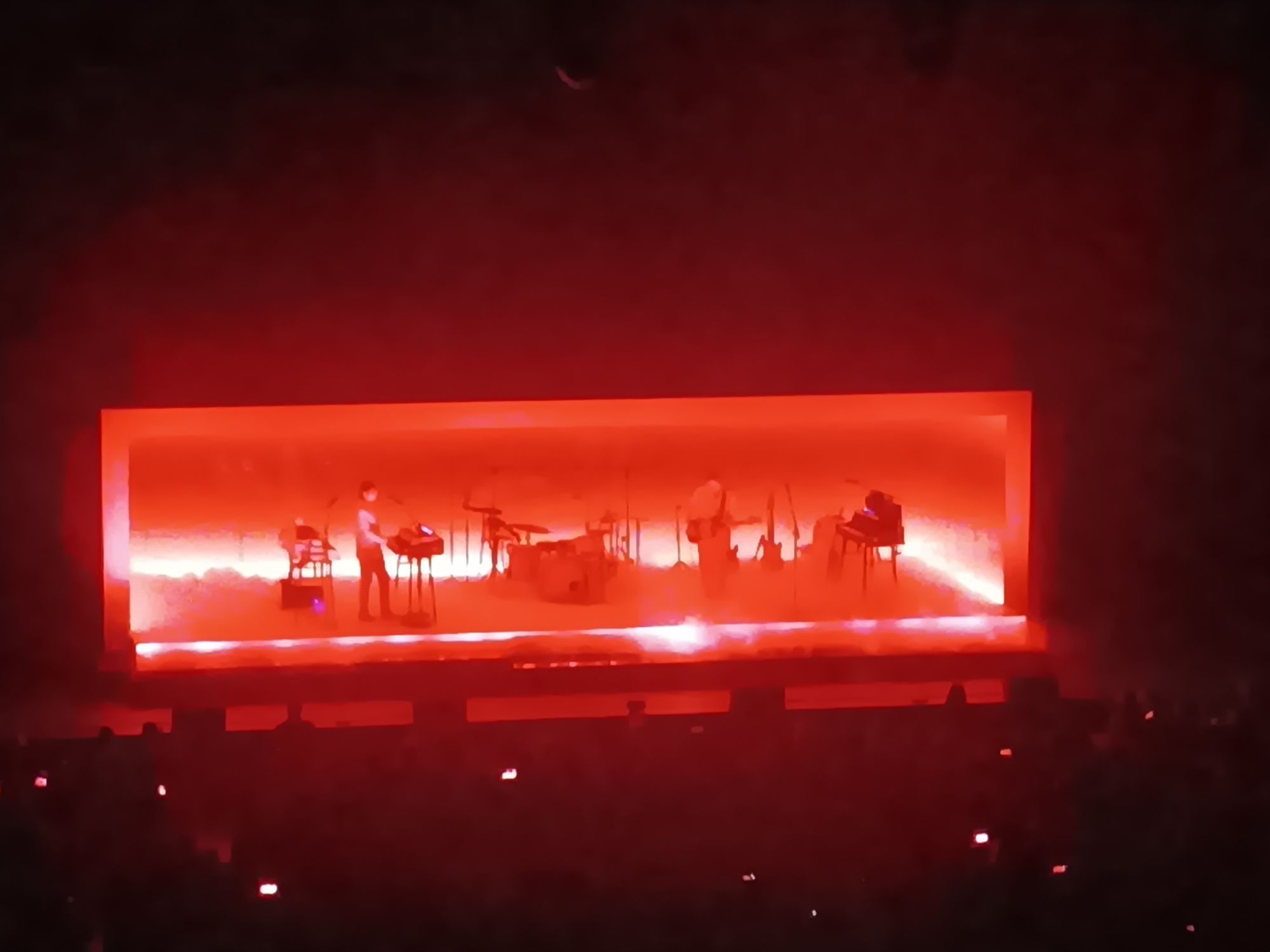 band playing on red lit stage