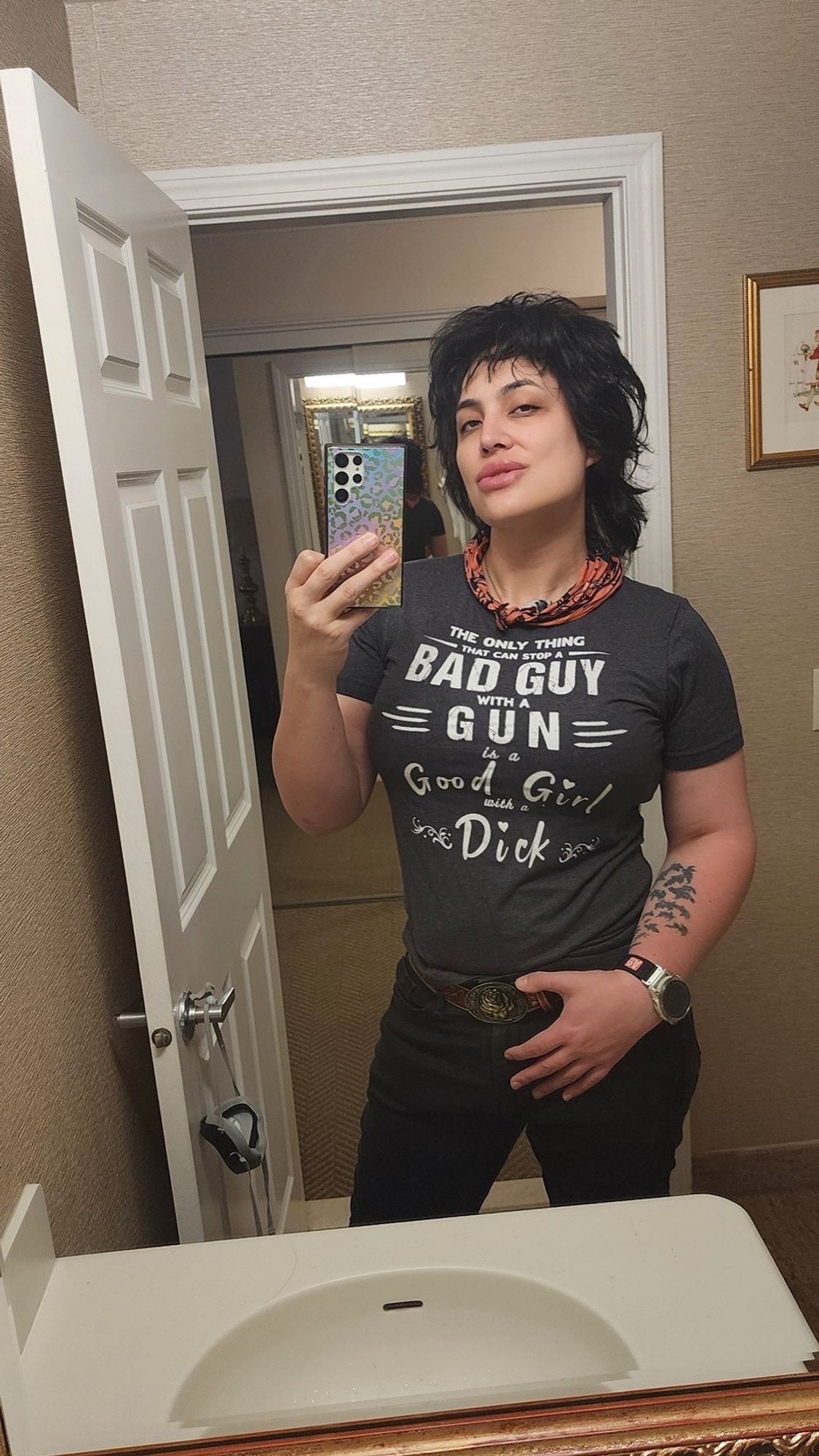 Nika wears a shirt which says "the only thing that can stop a bad guy with a gun is a good girl with a dick"