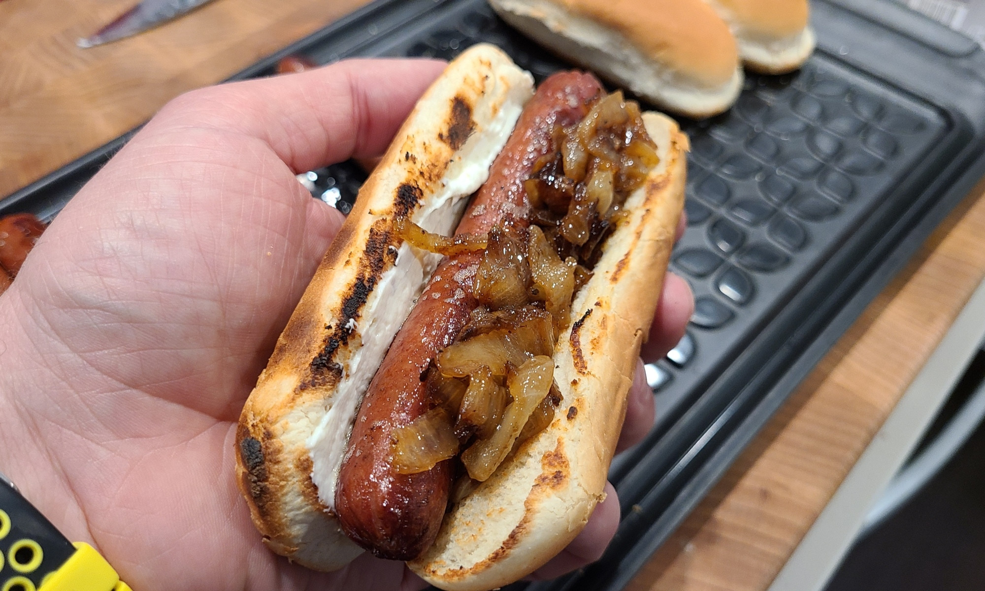 Fried hot dog in a toasted bun topped with cream cheese and grilled onions. Ideally, the hot dog or bratwurst is split before frying 