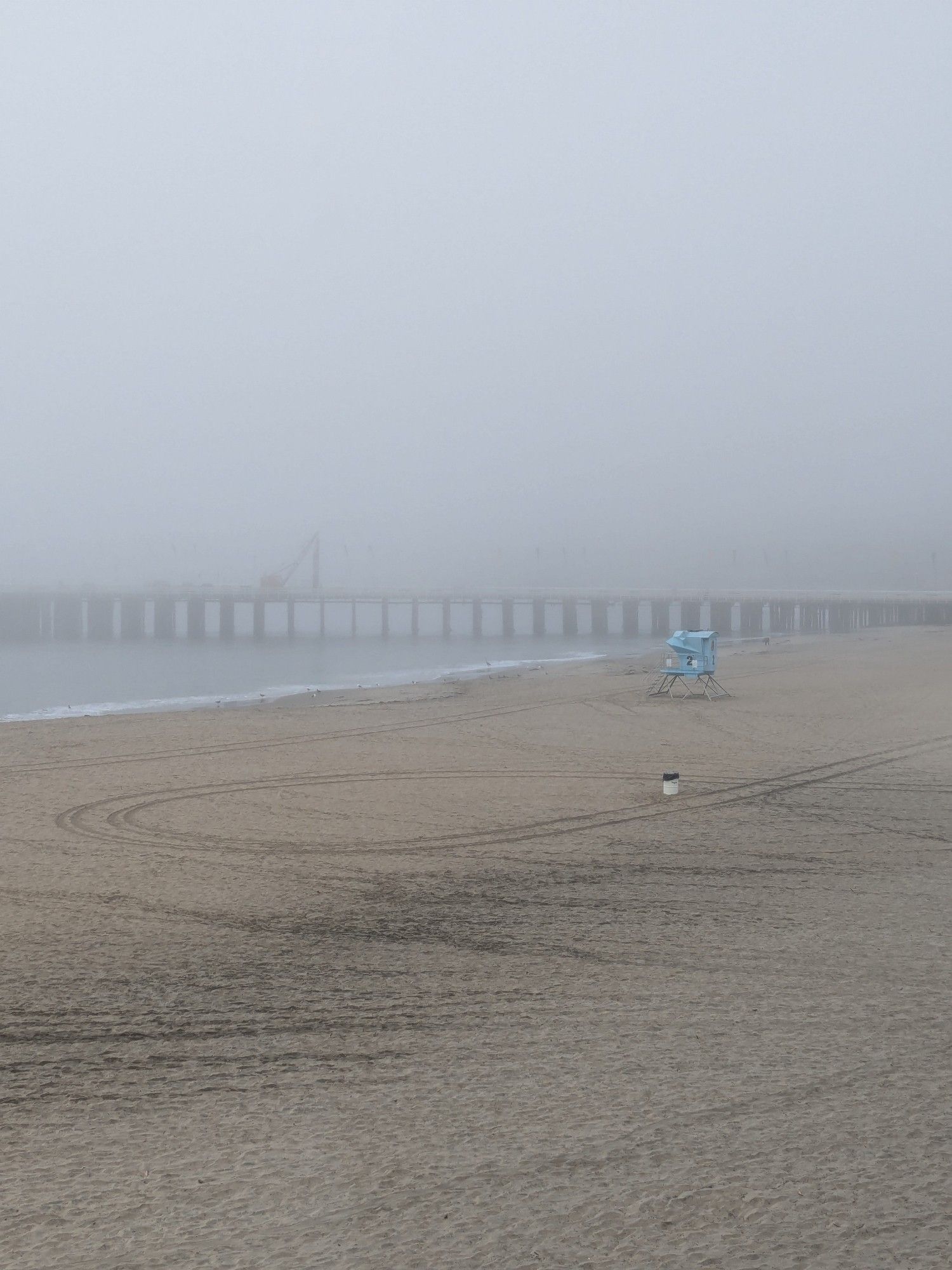 Picture of Santa Cruz main beach with the wharf shrouded in thick fog.