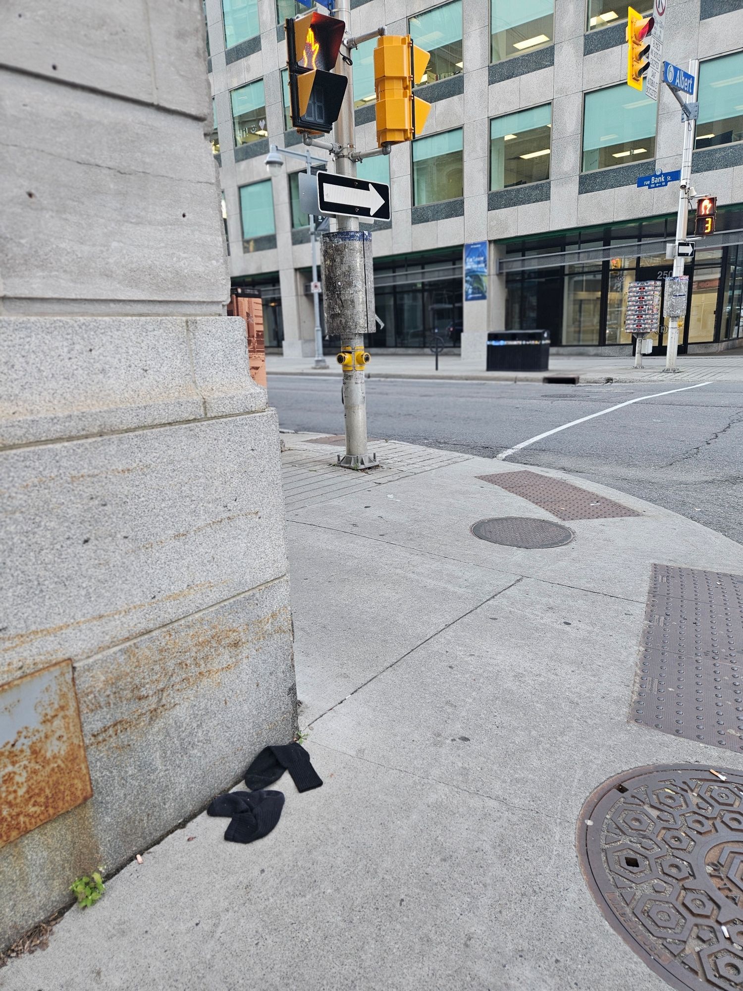 A pair of black athletic socks on a downtown street corner