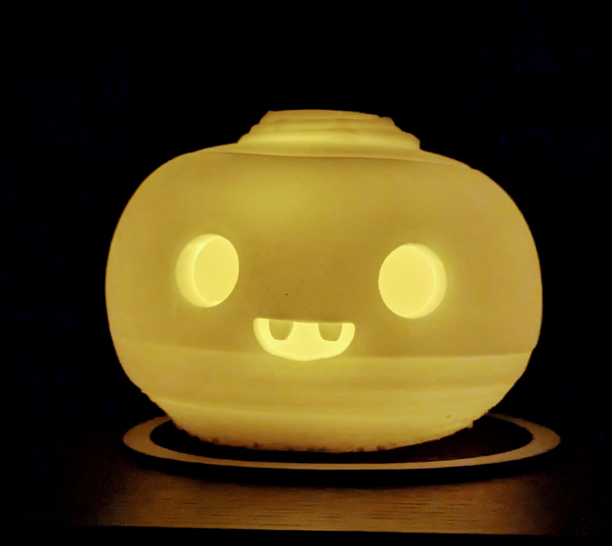 The same neep, but with the lights off so that we can see it glowing from within. These things aren't heat-resistant, so it's an LED tealight inside.