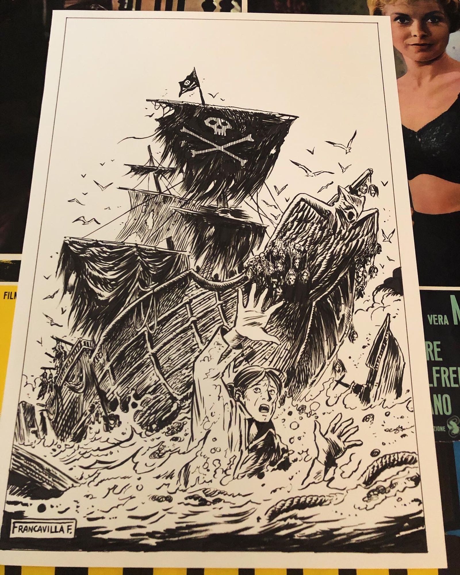 Original art of the pirate ship in the background and the survivor in the water in the foreground- sinking ships around