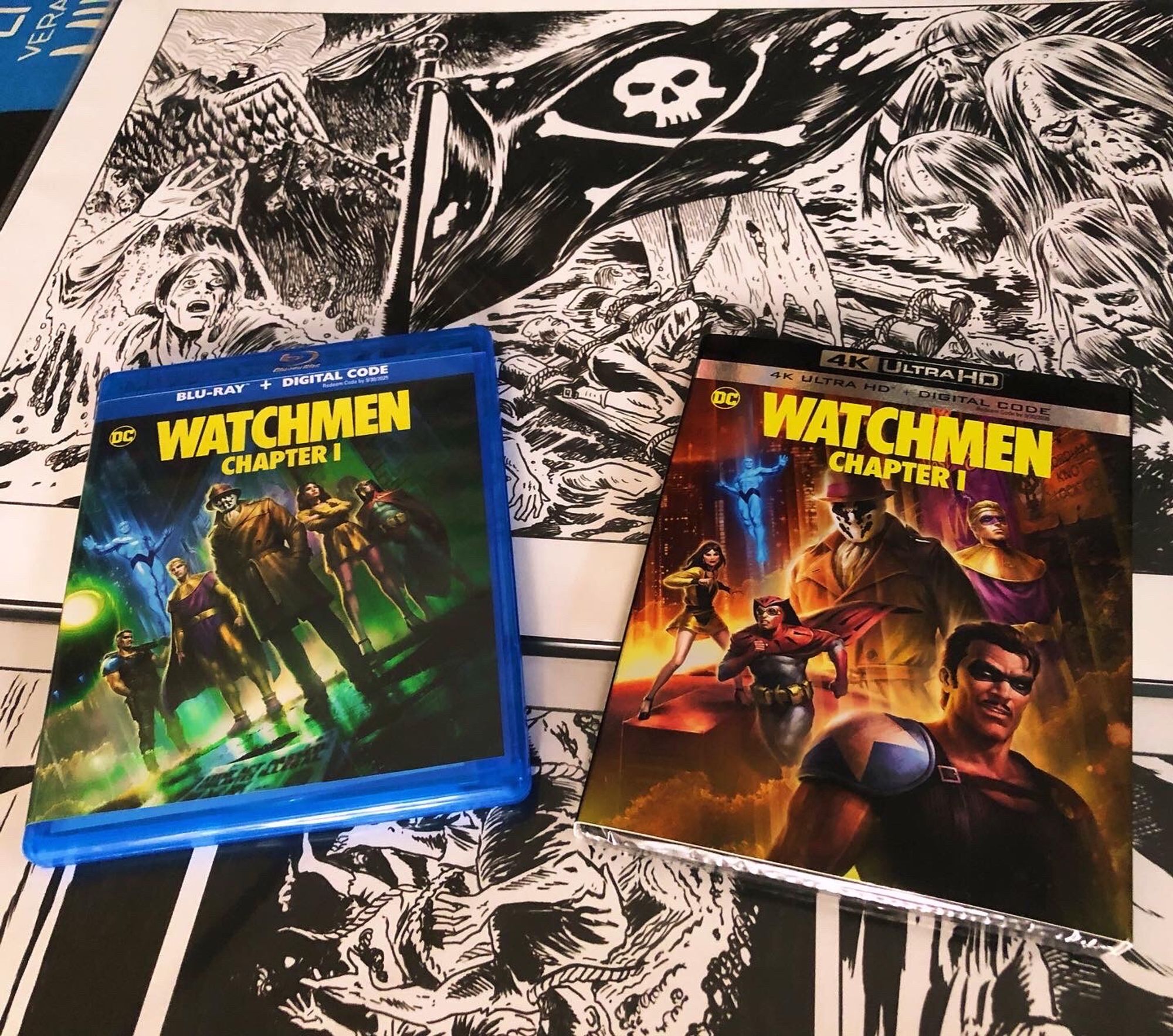 The Blu-ray and 4K uhd sets for Watchmen Chapter One sitting on the original art for the animated movie