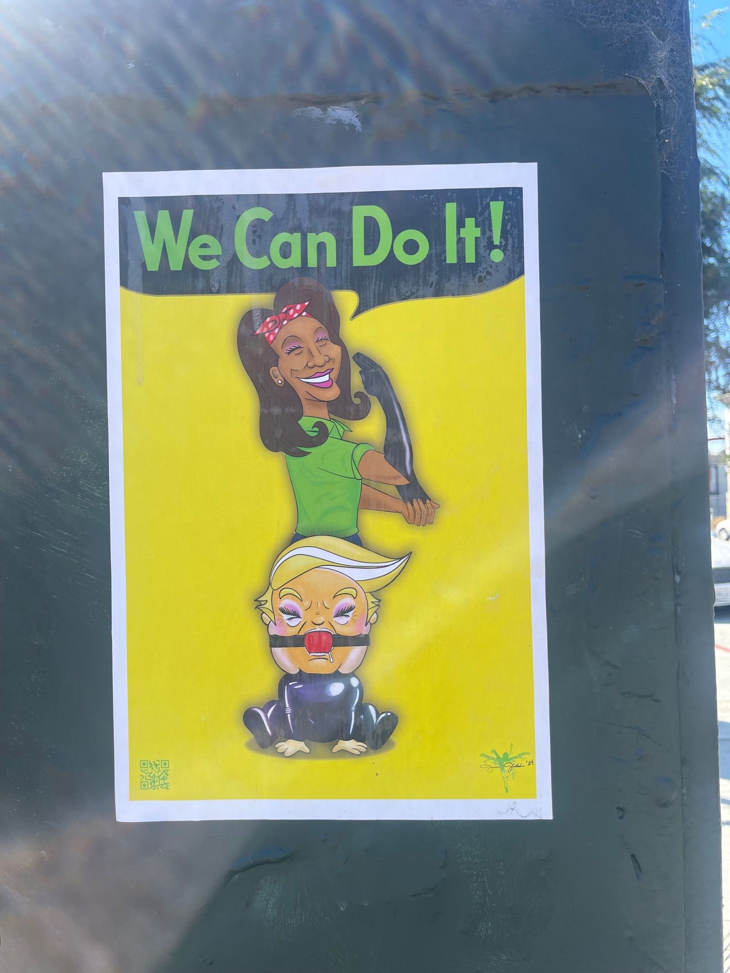 Poster in San Francisco - 
Kamala saying “we can do it” As a sort of “ Rosie, the Riveter” with a gagged Donald Trump beneath her as alá S&M