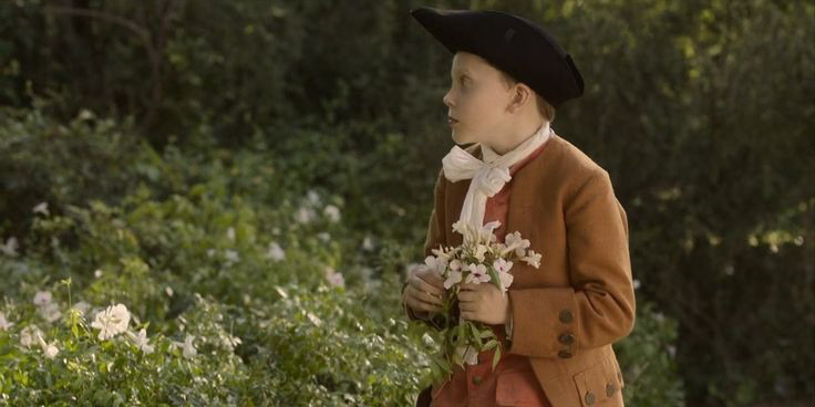 young stede bonnet picking flowers alone, looking off to the side away from the camera