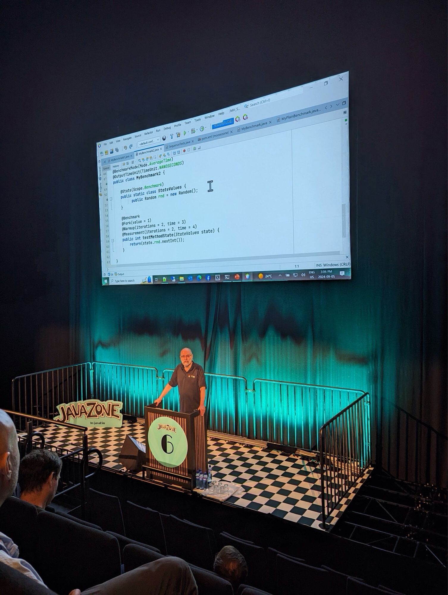 Photo of Ken Fogel presenting at the JavaZone conference in Oslo. Standing at podium with projection screen above me.