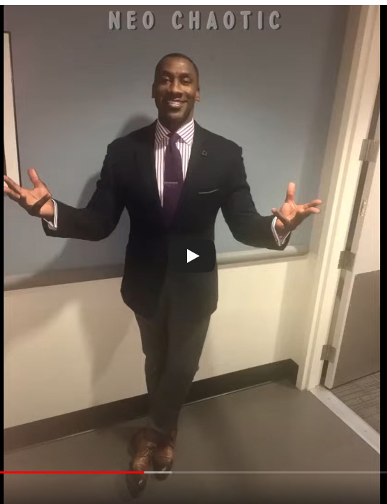 Shannon Sharpe in a snazzy suit, posing backstage before filming NFL gameday stuff