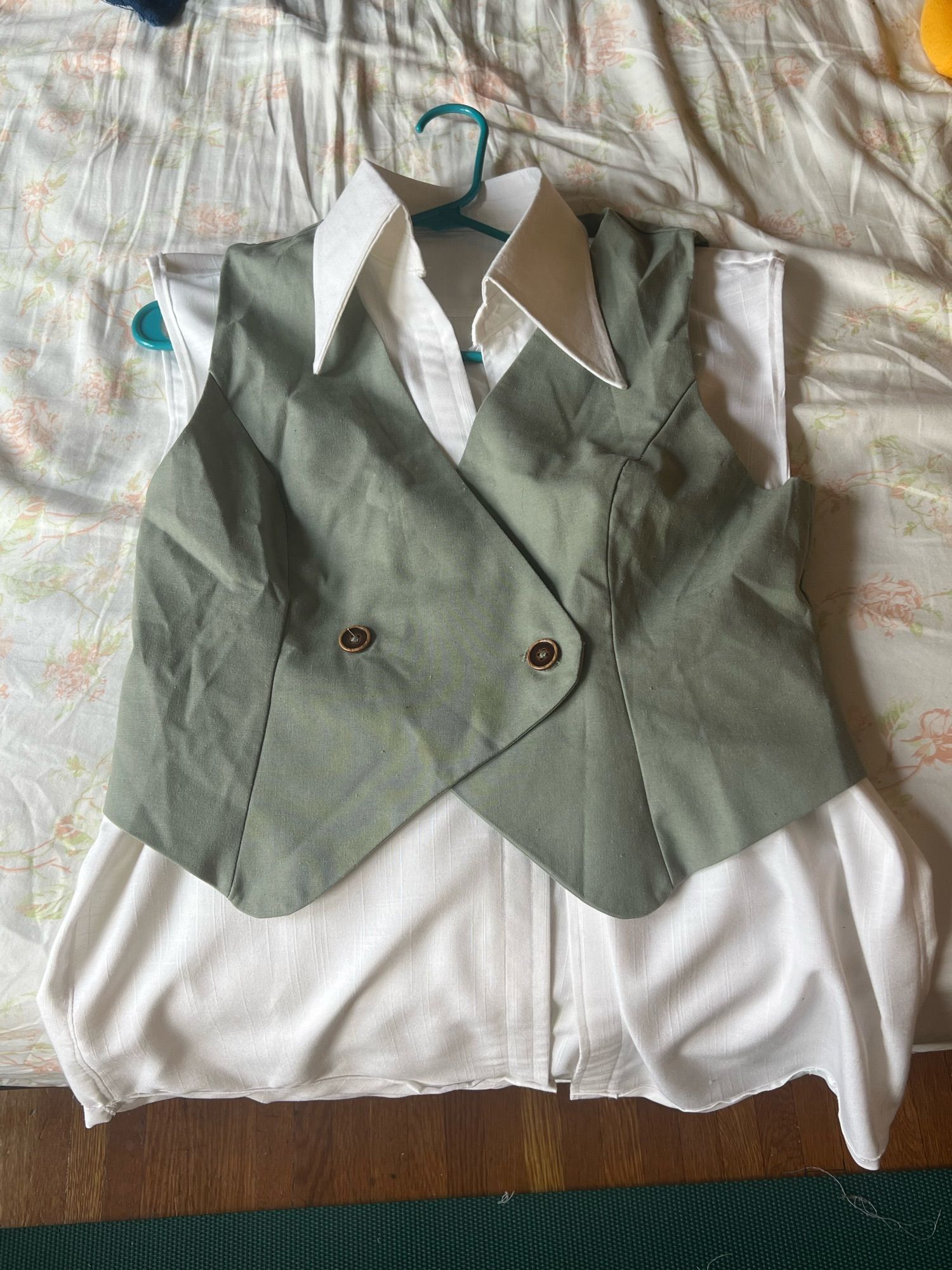 The white shirt with a matching olive green vest