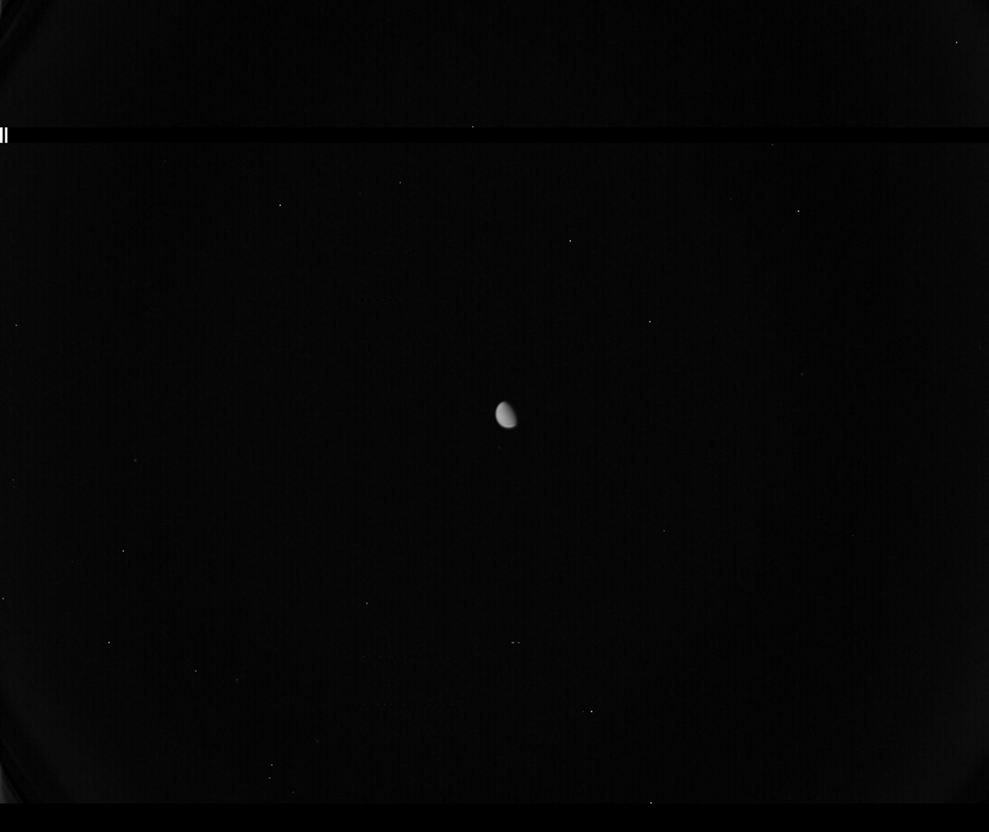 The image is mostly black. At the very center there is a small sphere, slightly more than half-full, a little planet in the forward view.