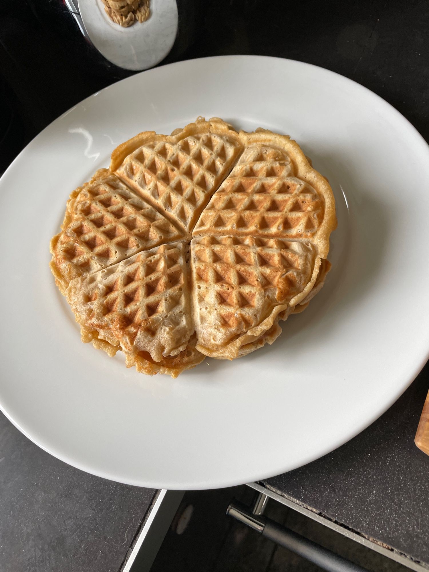 Einige fertige Waffeln liegen auf einem weißen Teller