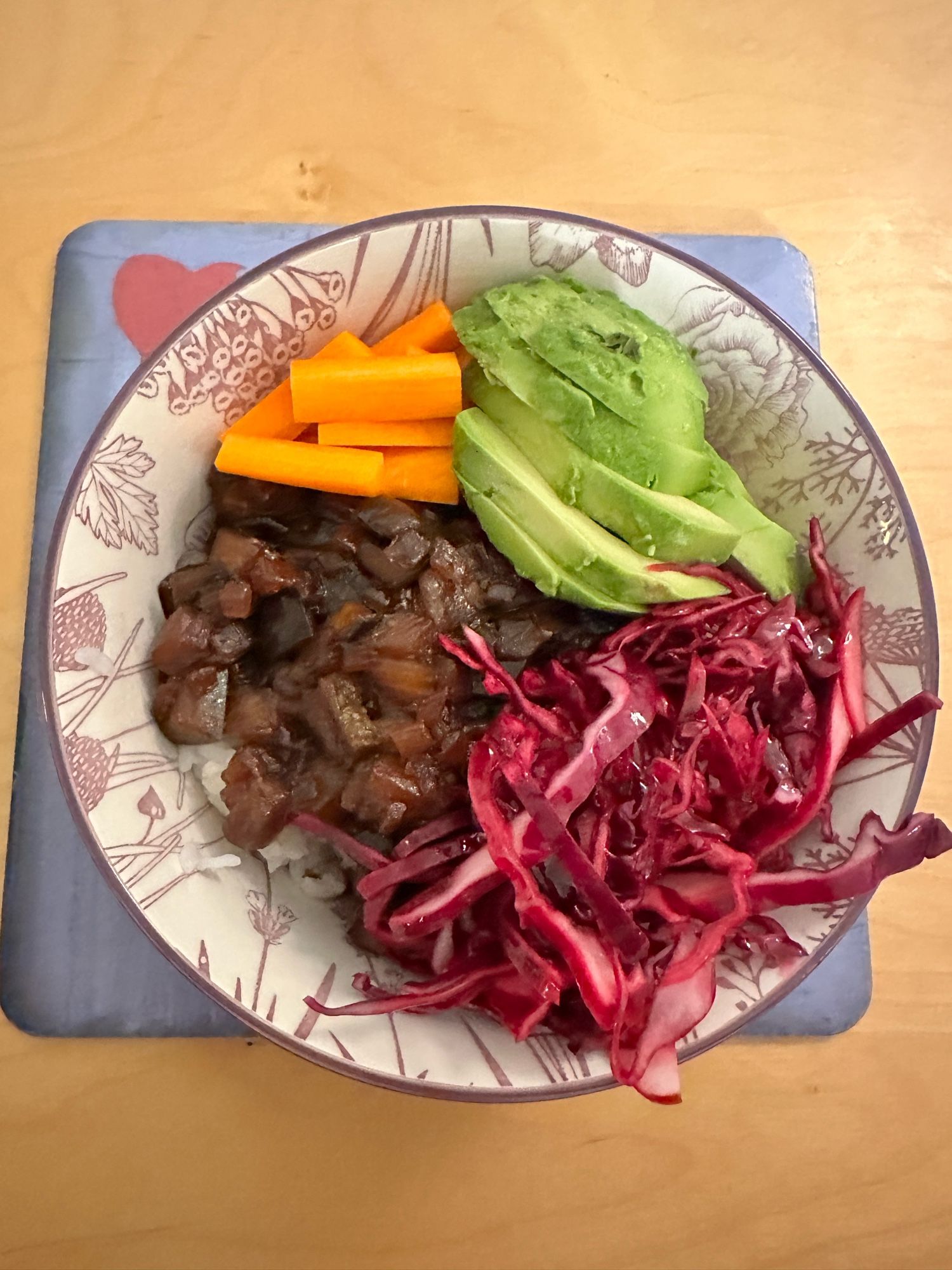 Don buri bowl with rice, eggplant, red cabbage, carrot and avocados