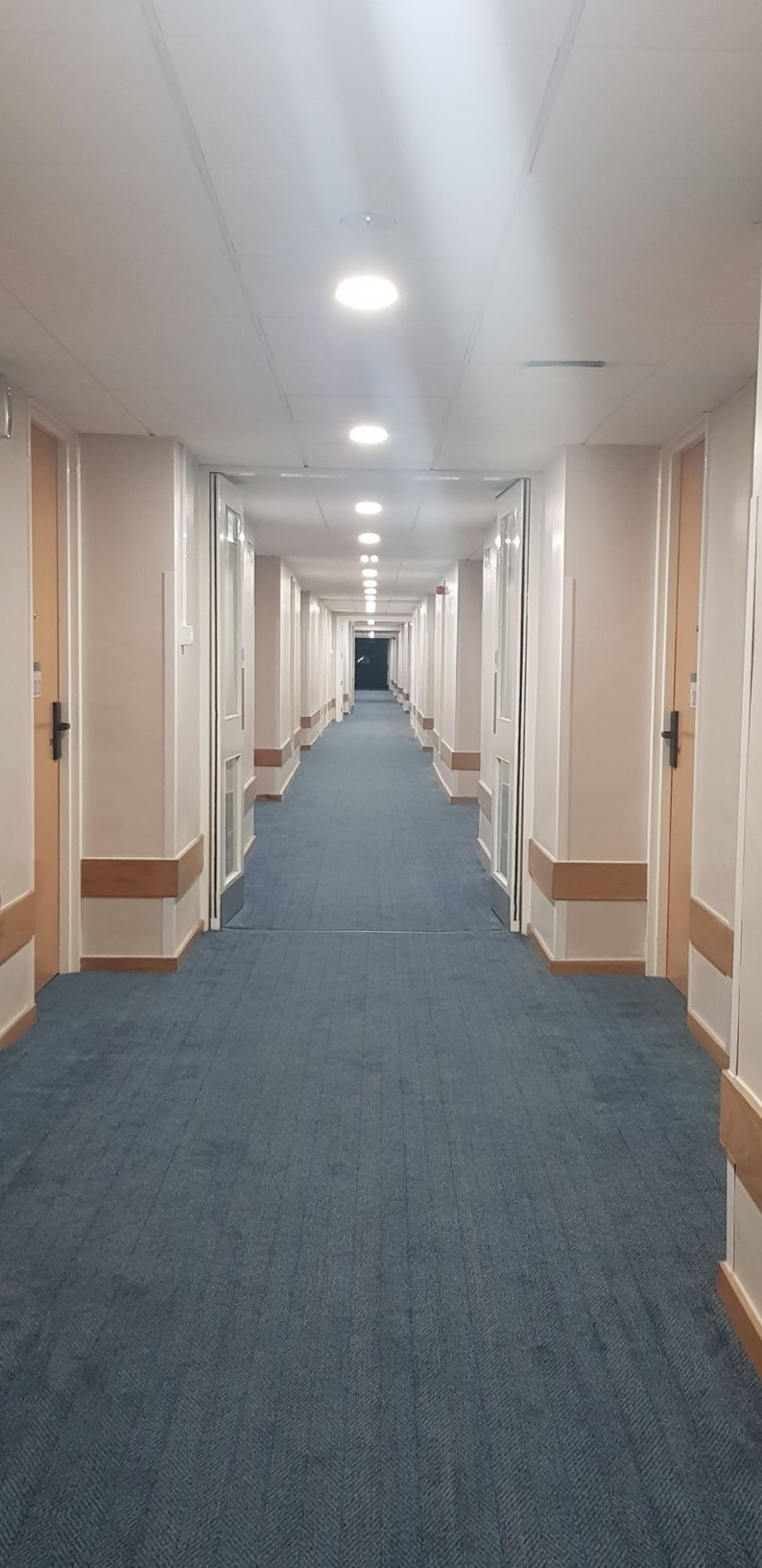 A long hotel corridor resembling the long corridor in the film The Shining