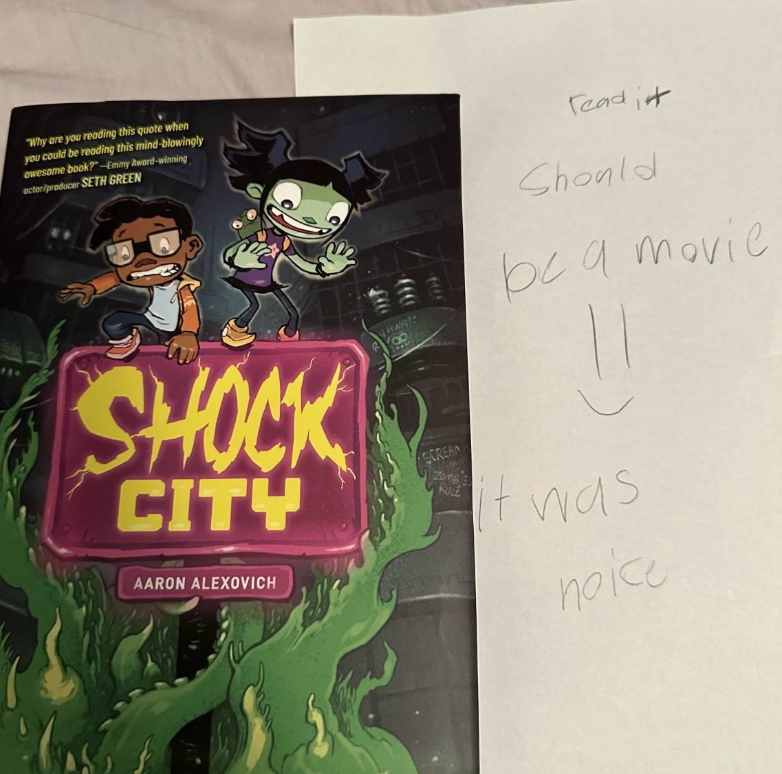 A kid’s hand-written review of the new horror comic SHOCK CITY. It says, “Read it. Should be a movie. :) It was noice.”