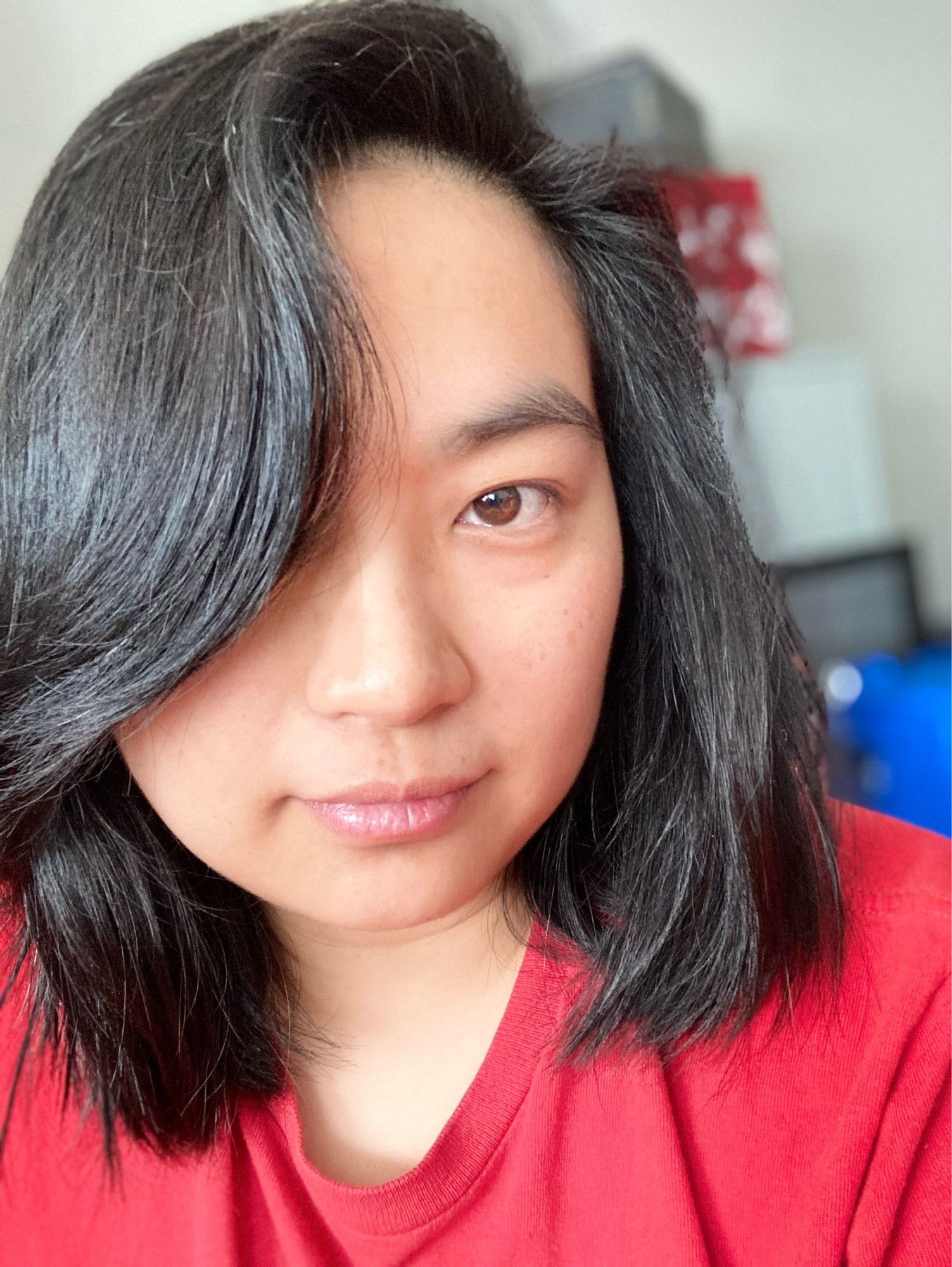 selfies of nonbinary Asian person, indoors with good lighting, no glasses, red T-shirt