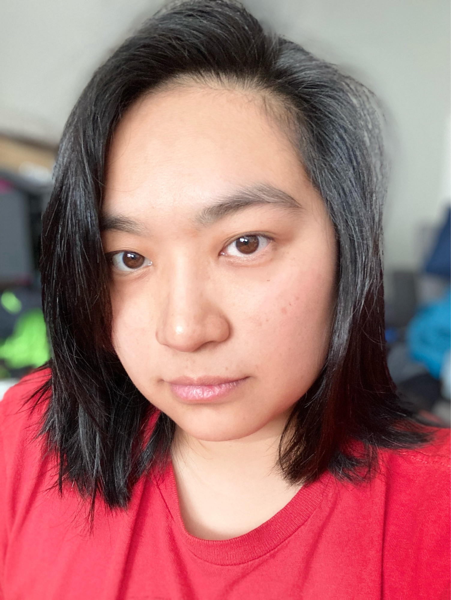 selfies of nonbinary Asian person, indoors with good lighting, no glasses, red T-shirt