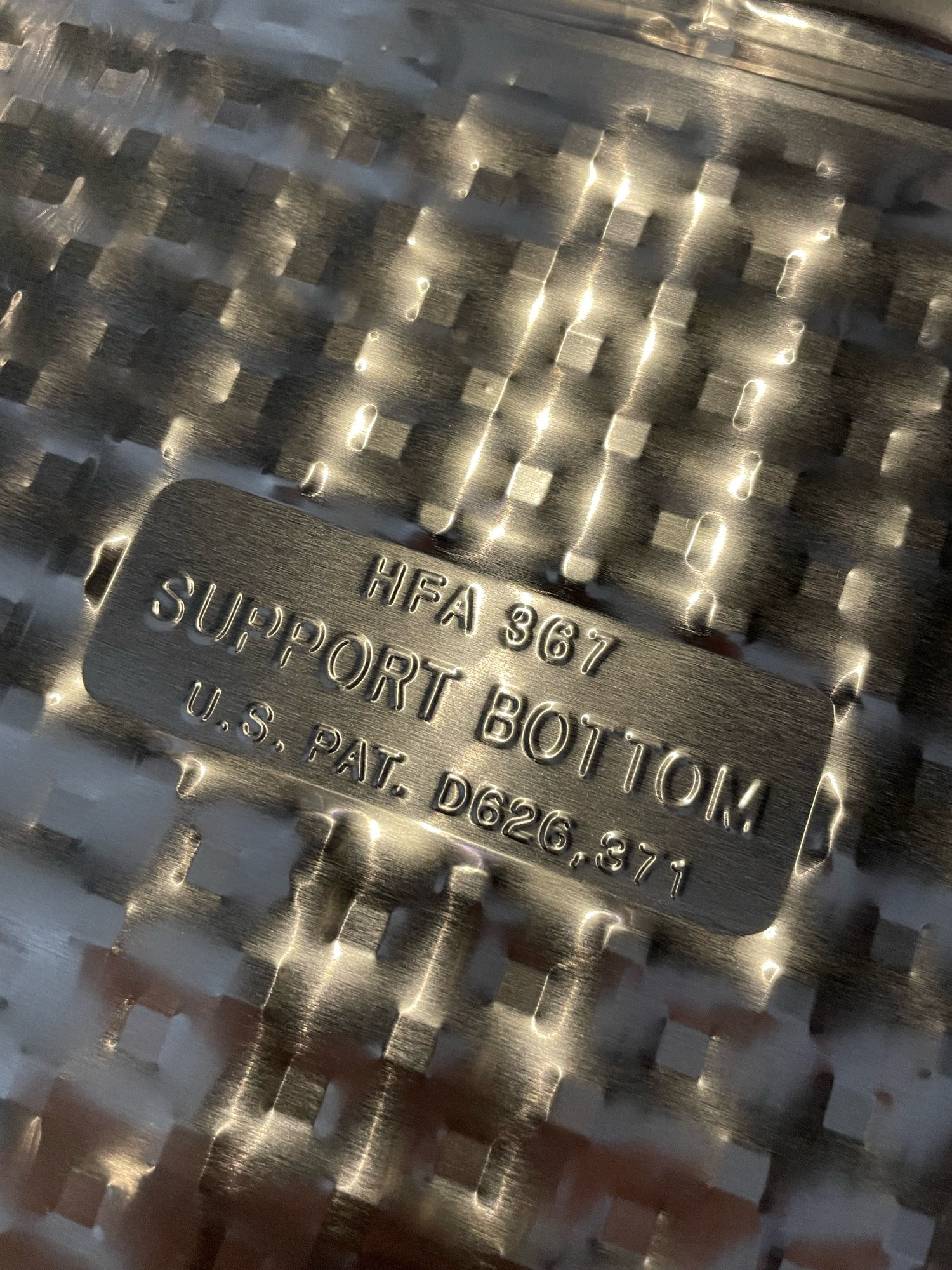 Underside of an aluminum pan that says “support bottom.”