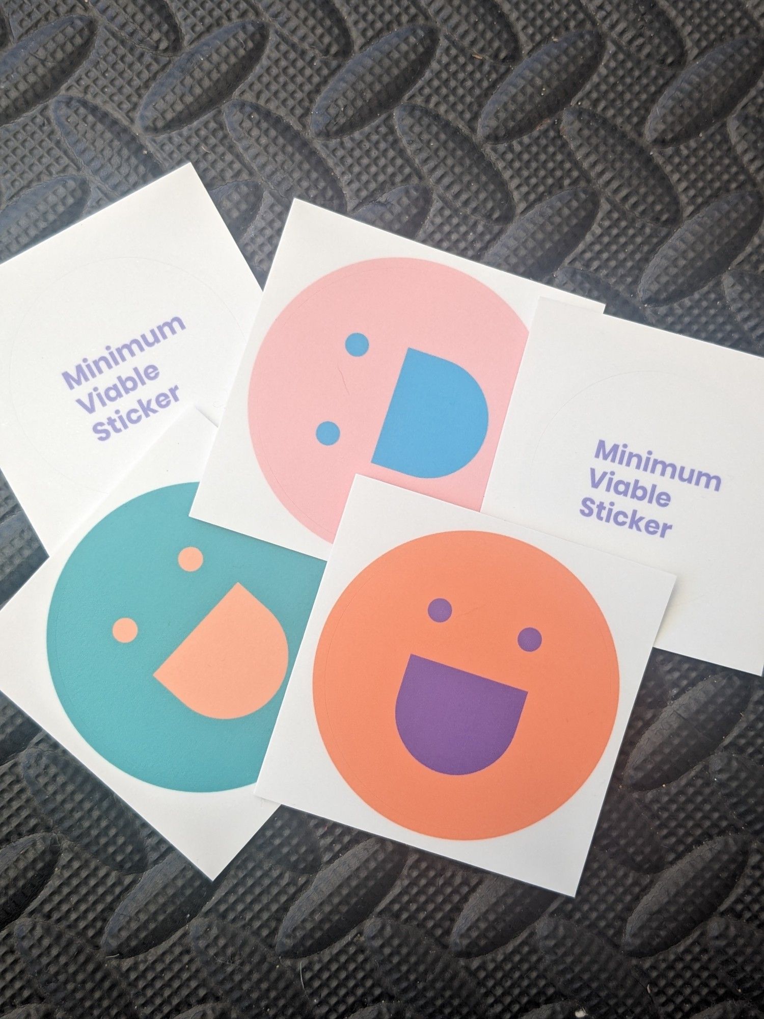 dxw smiley face stickers and minimum viable stickers