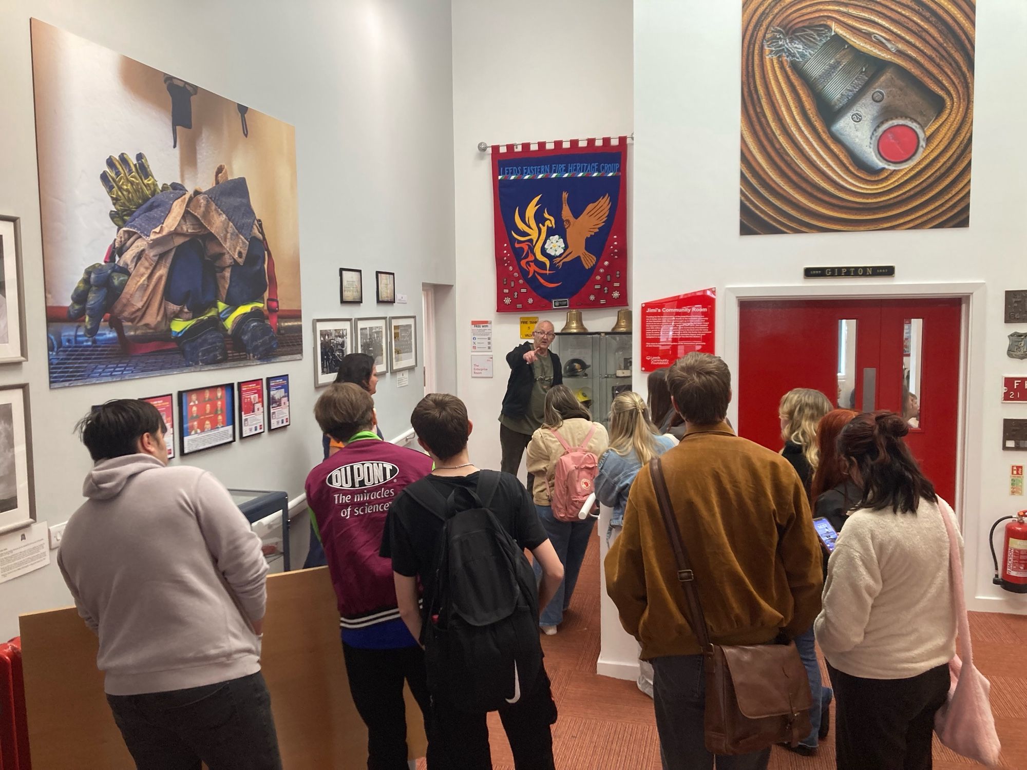 Retired firefighter Trevor Leighton giving students a tour of the former fire station at Gipton.