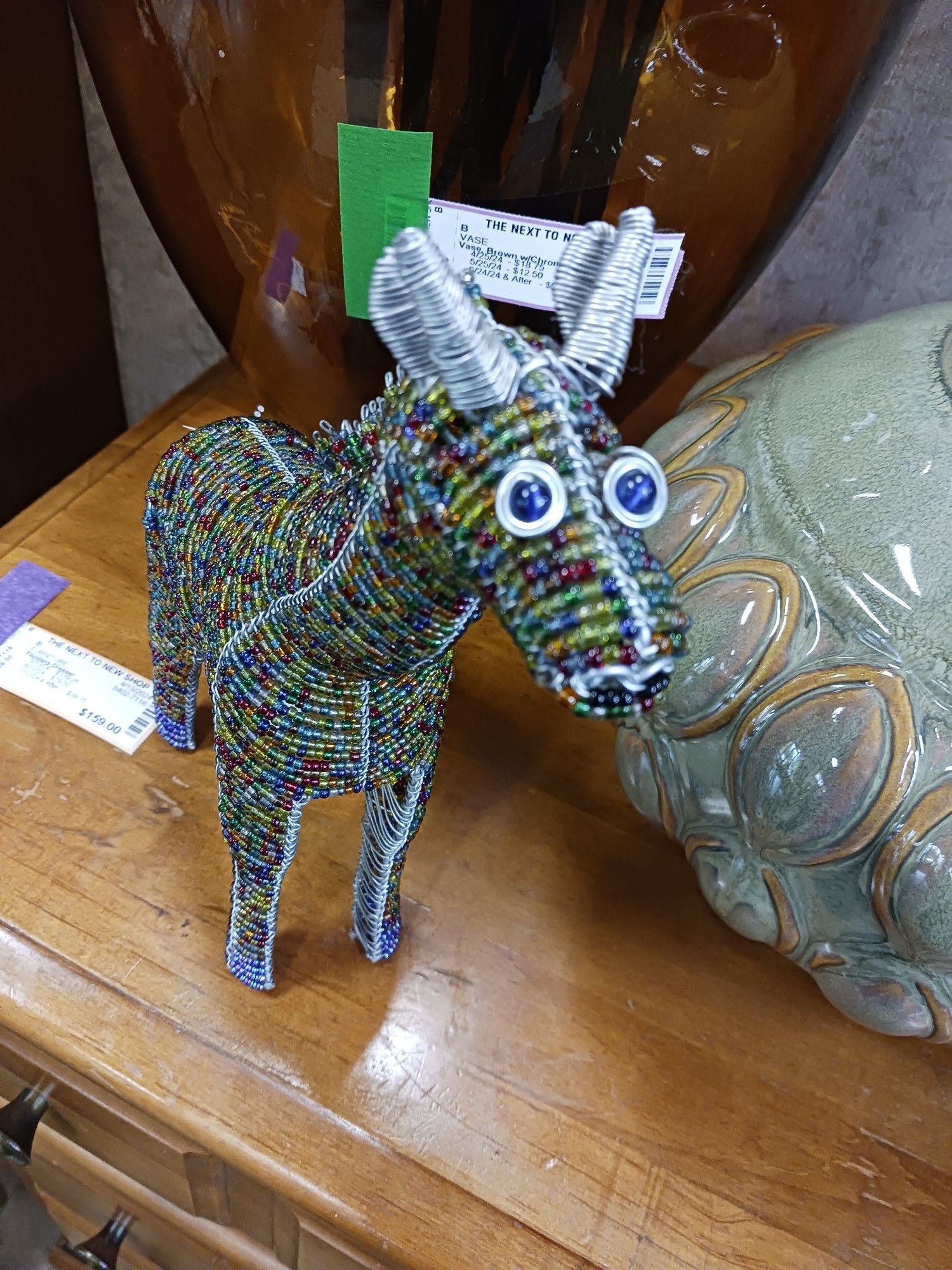 A colorful donkey made of beads and wire with very big eyes