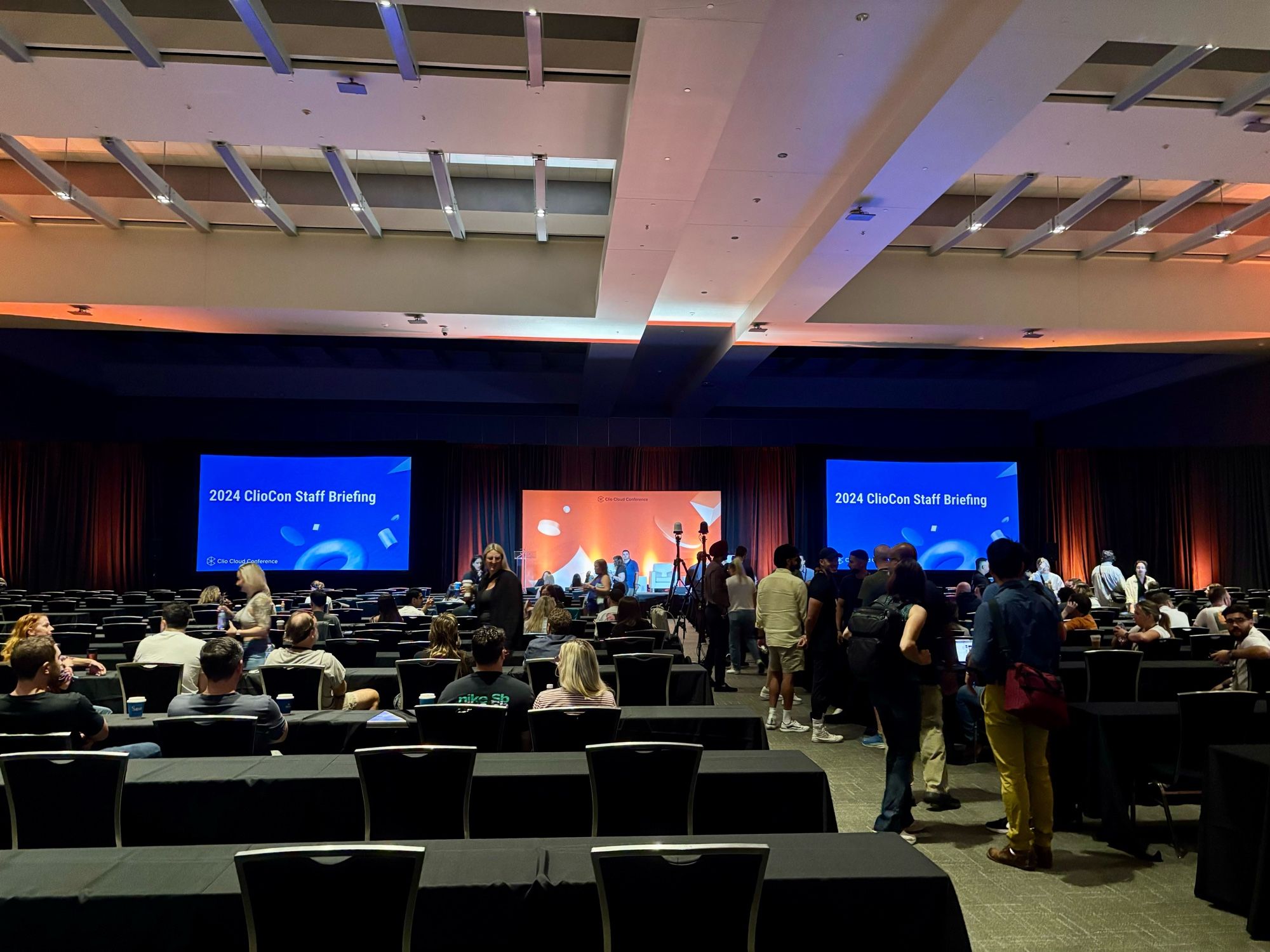 Team Clio meeting in a conference center ballroom.