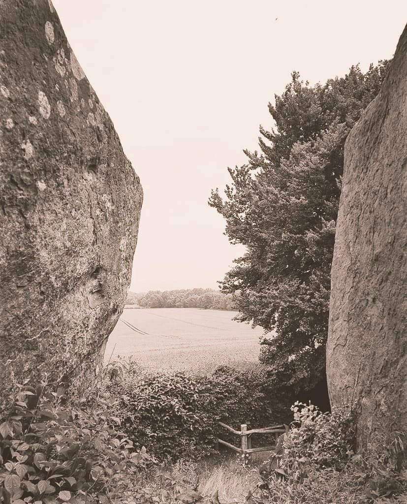 A photo taken from inside the main chamber looking out across farmland