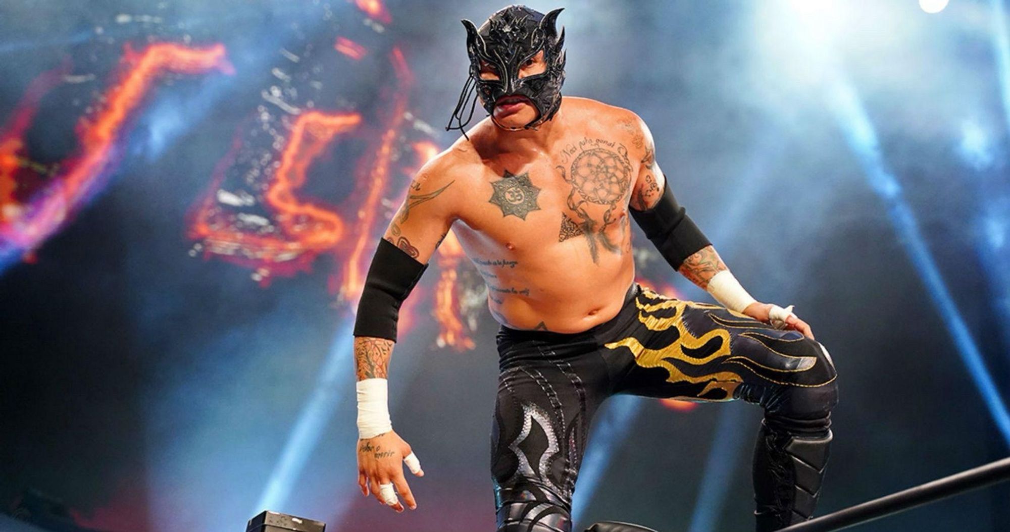 Rey Fenix in black mask and black tights with silver and golden flames