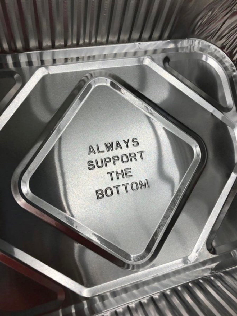 A foil pan with the words "ALWAYS SUPPORT THE BOTTOM" embossed