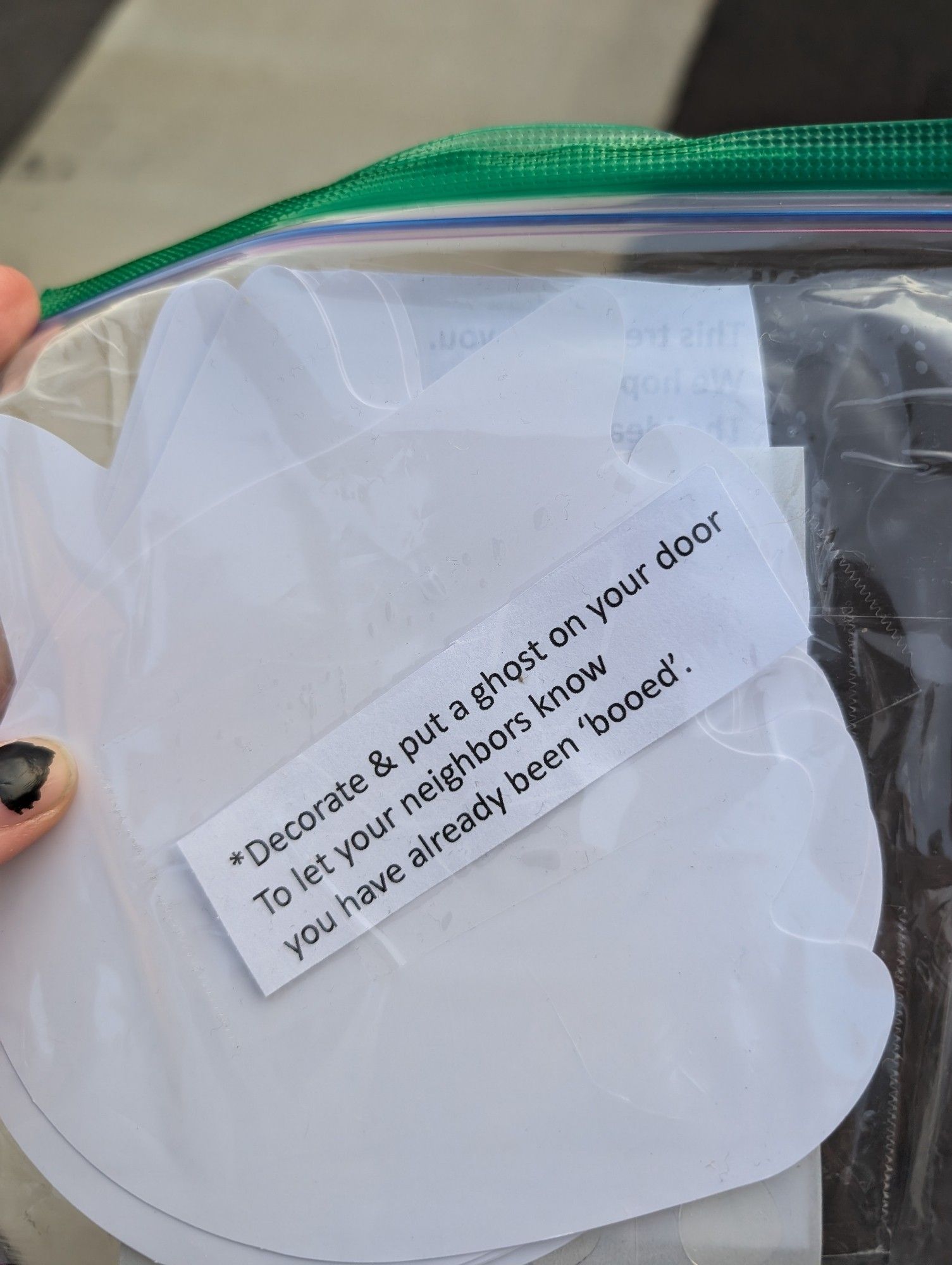 Same plastic bag, on the other side it says "decorate and put a ghost on your door to let your neighbors know you have already been "booed."