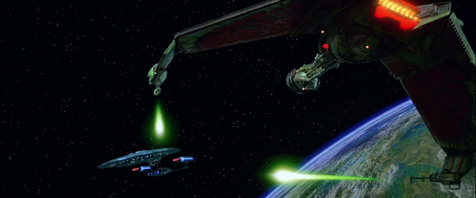 A Klingon Bird of Prey firing its disruptors at the Enterprise-D