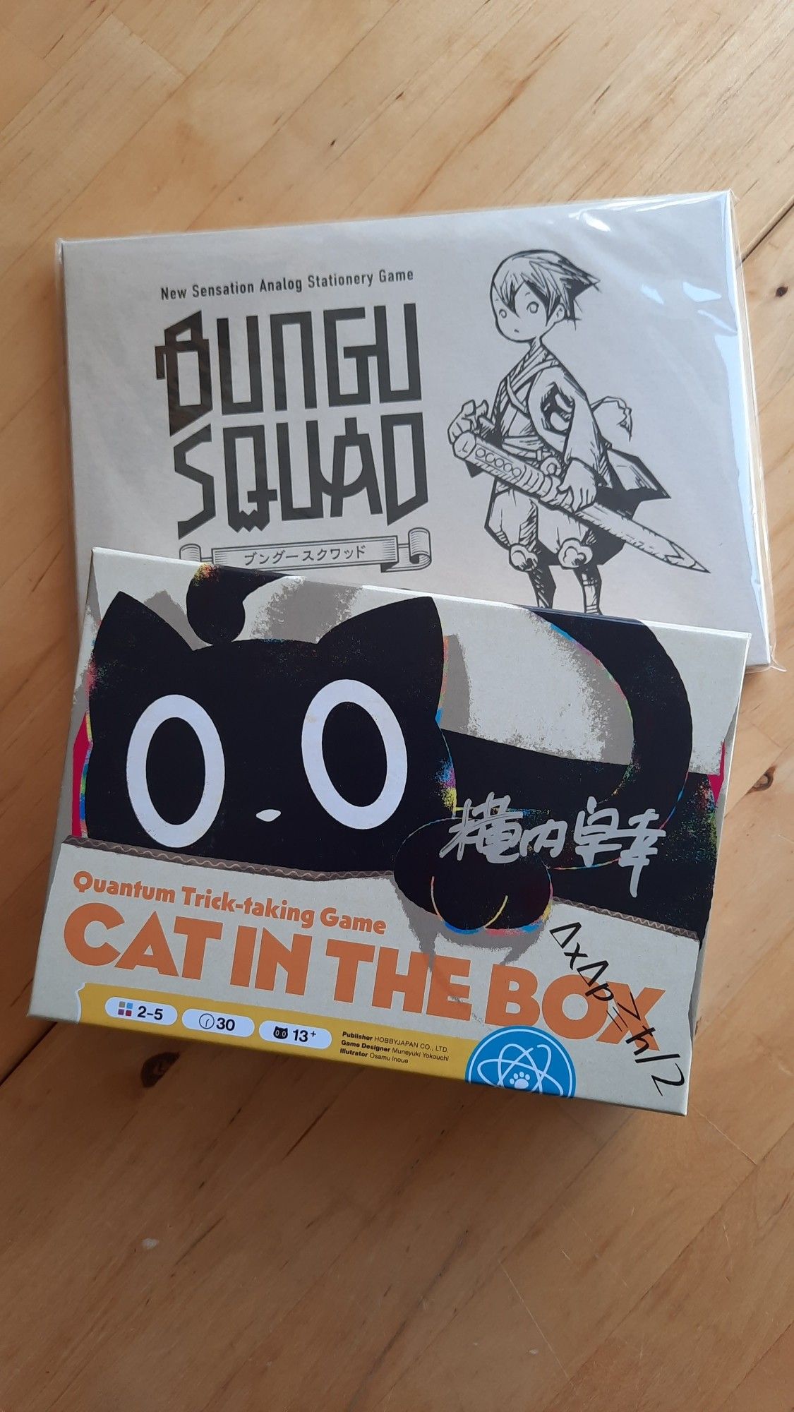 Two japanese board games. one is cat in the box and the other one is bungu squad