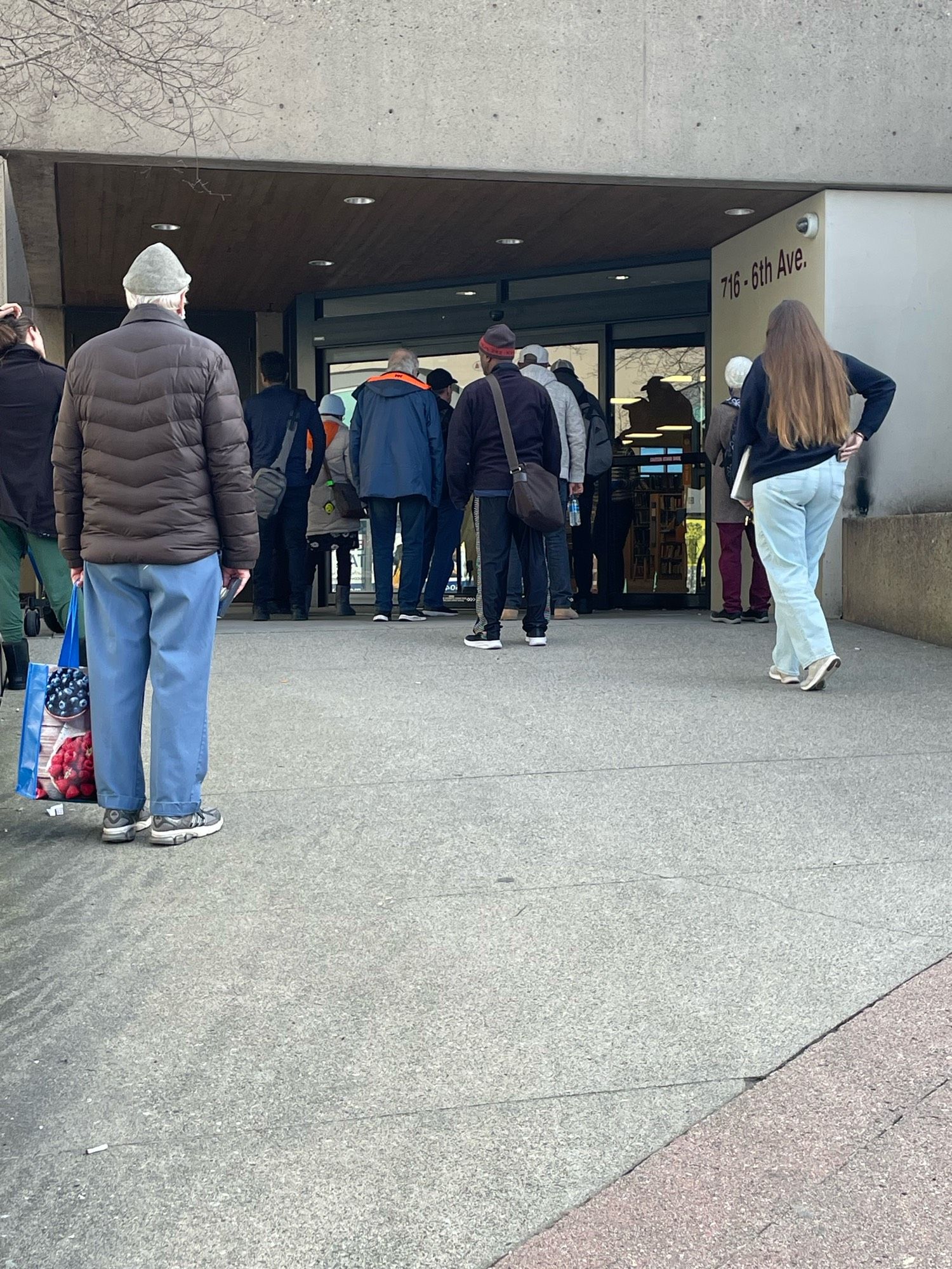 Group of people outside library doors.