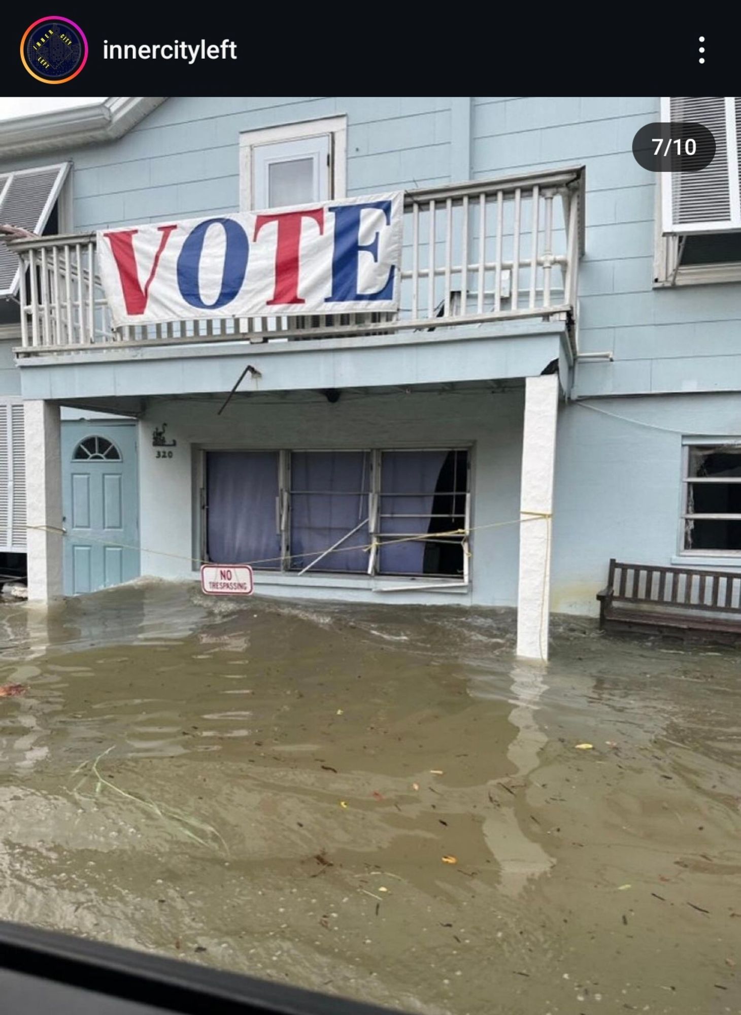 A "VOTE" banner above an entrance and a few feet of water