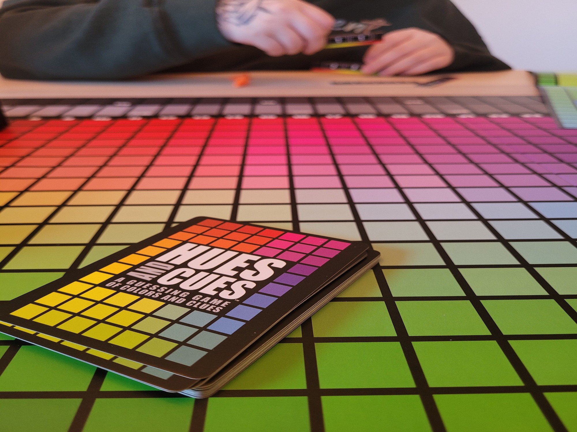 hues and cues a board game with a bunch of rainbow colored squares