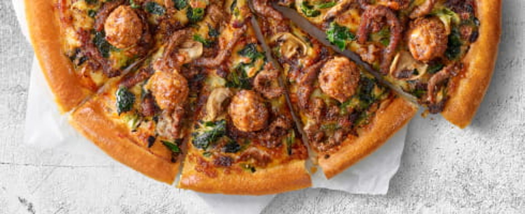 Black pepper beef and beef meatball pizza.