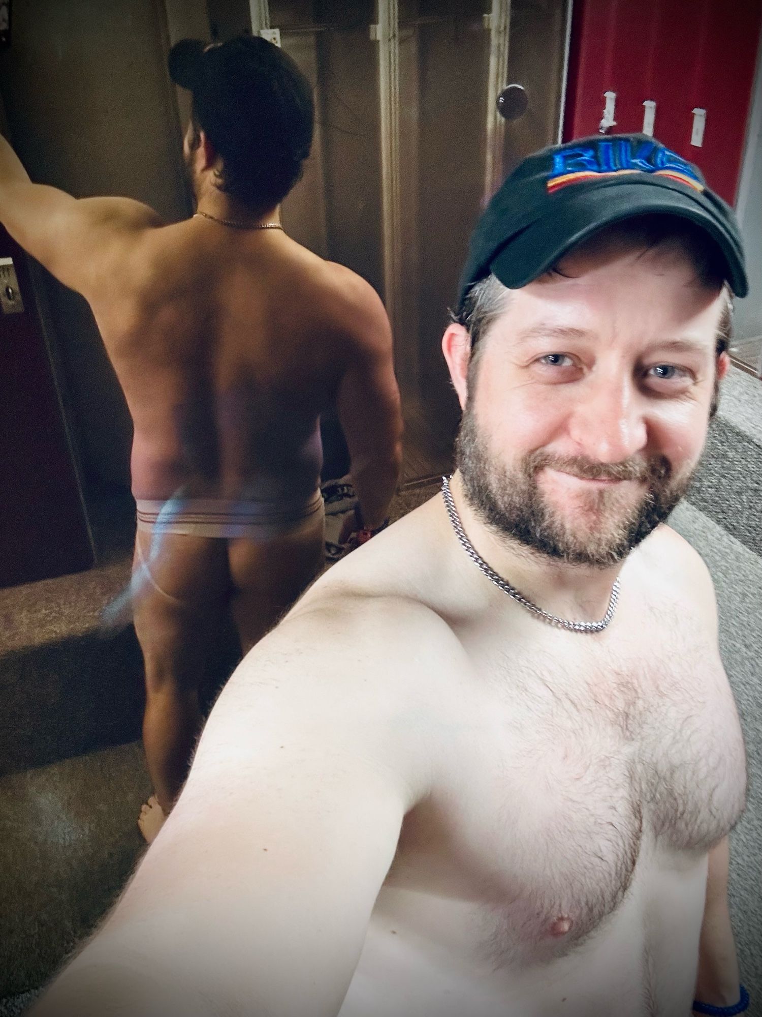 Gay man shows the backside of his classic Bike jock while contemplating how dirty the gym mirror is and whether it’s his responsibility to clean it?