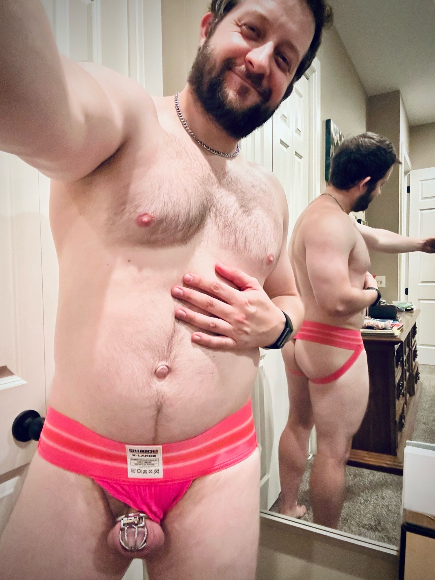 Gay man proudly showing off his caged dick and pink jock, with a smile disguising his Wednesday exhaustion!