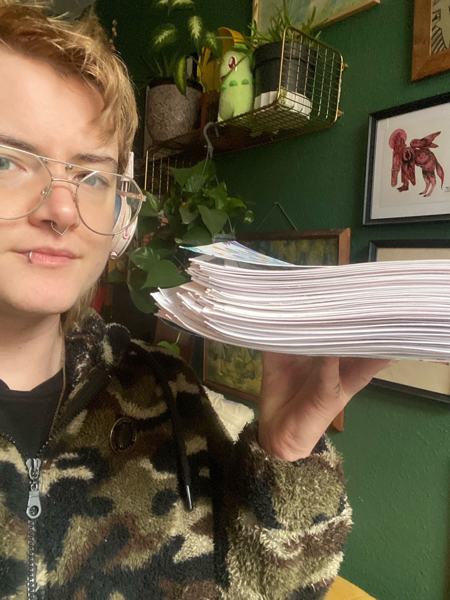 B holds up a fat stack of completed comic pages